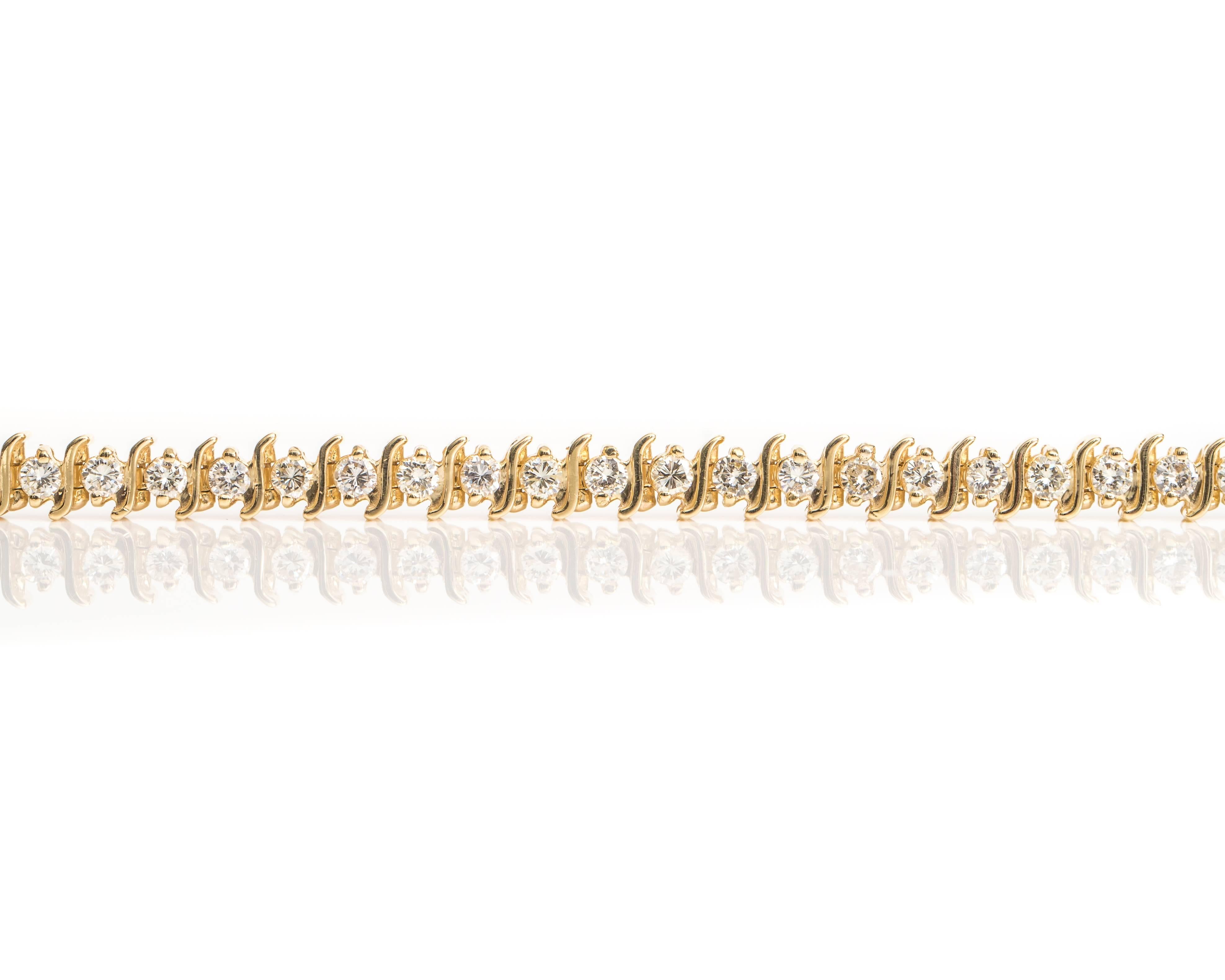 This stunning 1960s Retro S-Link Diamond Tennis Bracelet is a Luxury Classic. It features 6.0 Carats of Round Brilliant Diamonds set in 14 Karat Yellow Gold. The 14 Karat Yellow Gold S-Links separate each of the 35 Diamonds for optimal sparkle and