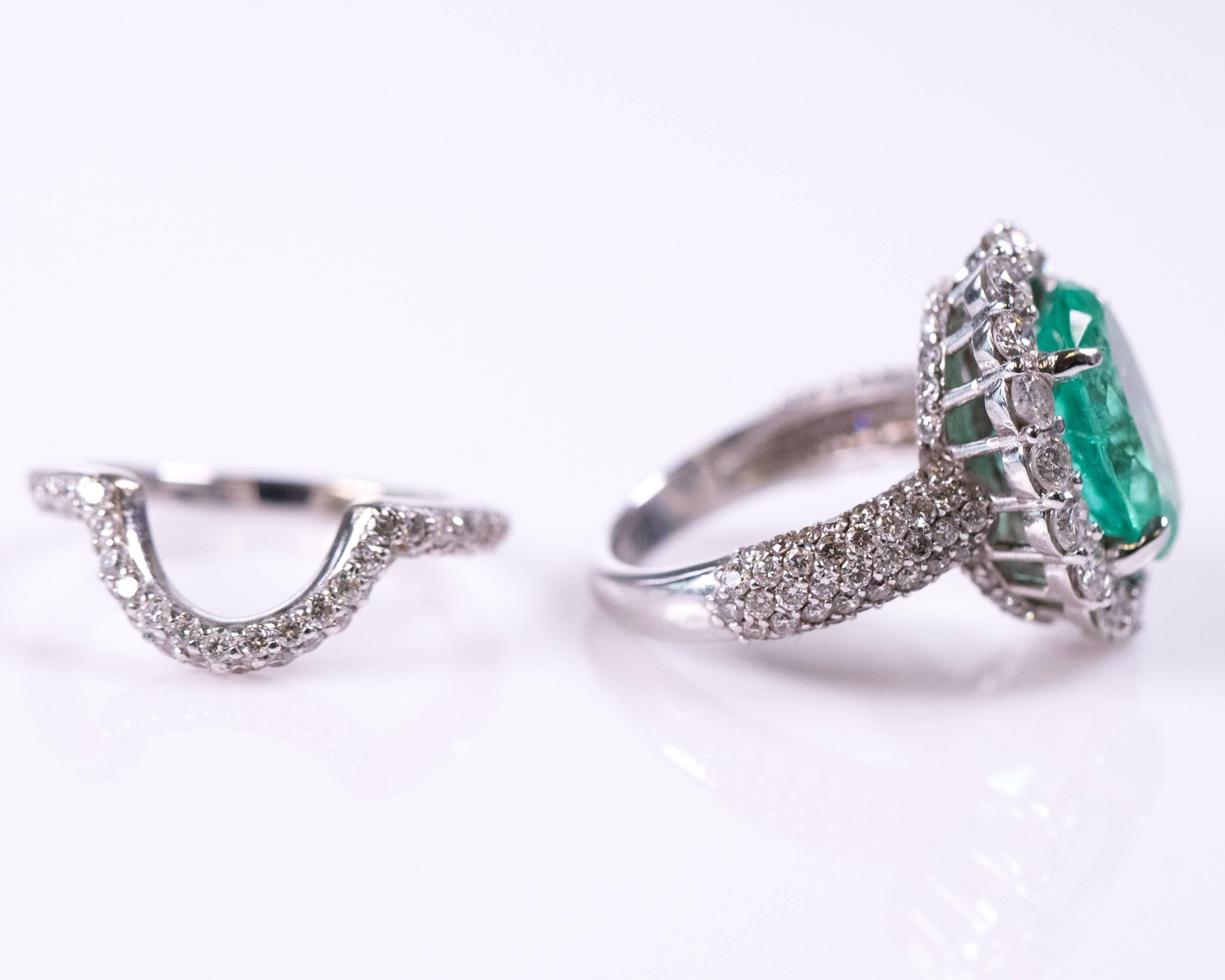 This Wedding Ring Set features a gorgeous 5 Carat Emerald Diamond ring, accompanied with a matching diamond band, which can double as a Cocktail Ring. The Emerald Ring features a Diamond Halo, a diamond bridge profile and 5 rows of diamonds on the