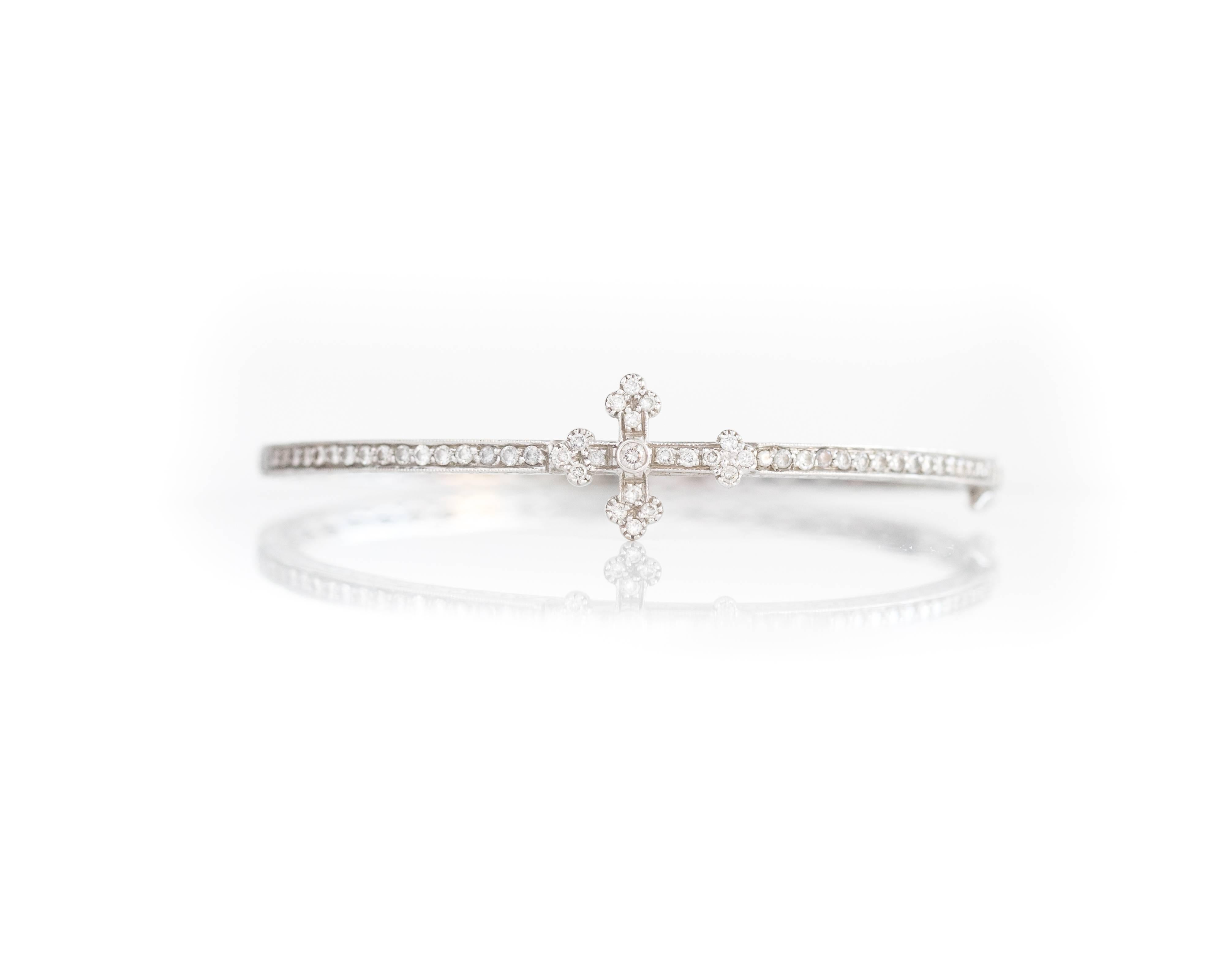 This Jude Frances Guinevere Bangle features 18 karat white gold with a pave and bezel set diamond cross on a pave diamond  bracelet. This hinged bangle bracelet has a safety clasp and fits up to a 7.25 inch wrist. 


Bracelet Details:
Metal Type: 18