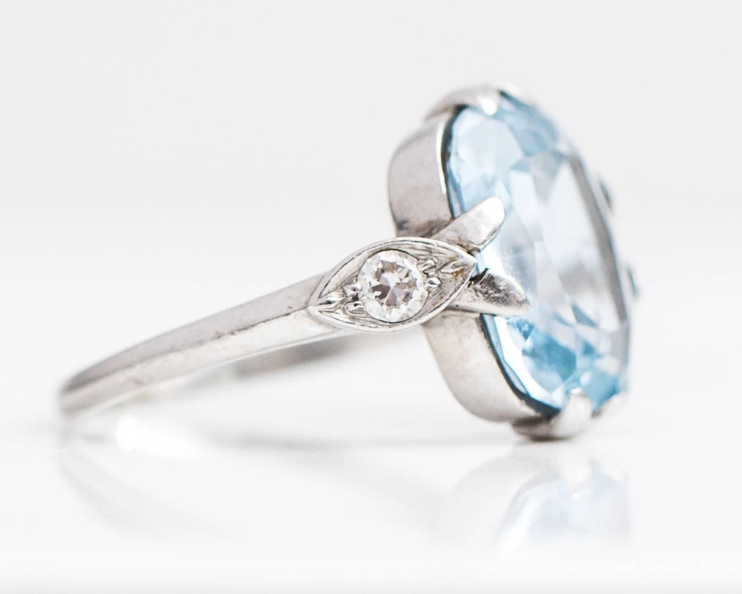 1935 Art Deco 3.5 Carat Aquamarine with .10 carat total weight Old European Cut Diamonds and Platinum Ring. The Old Cushion Cut Aquamarine has a clear Sea-foam Greenish Blue color and measures 13 millimeters long by 9 millimeters wide. The cut is