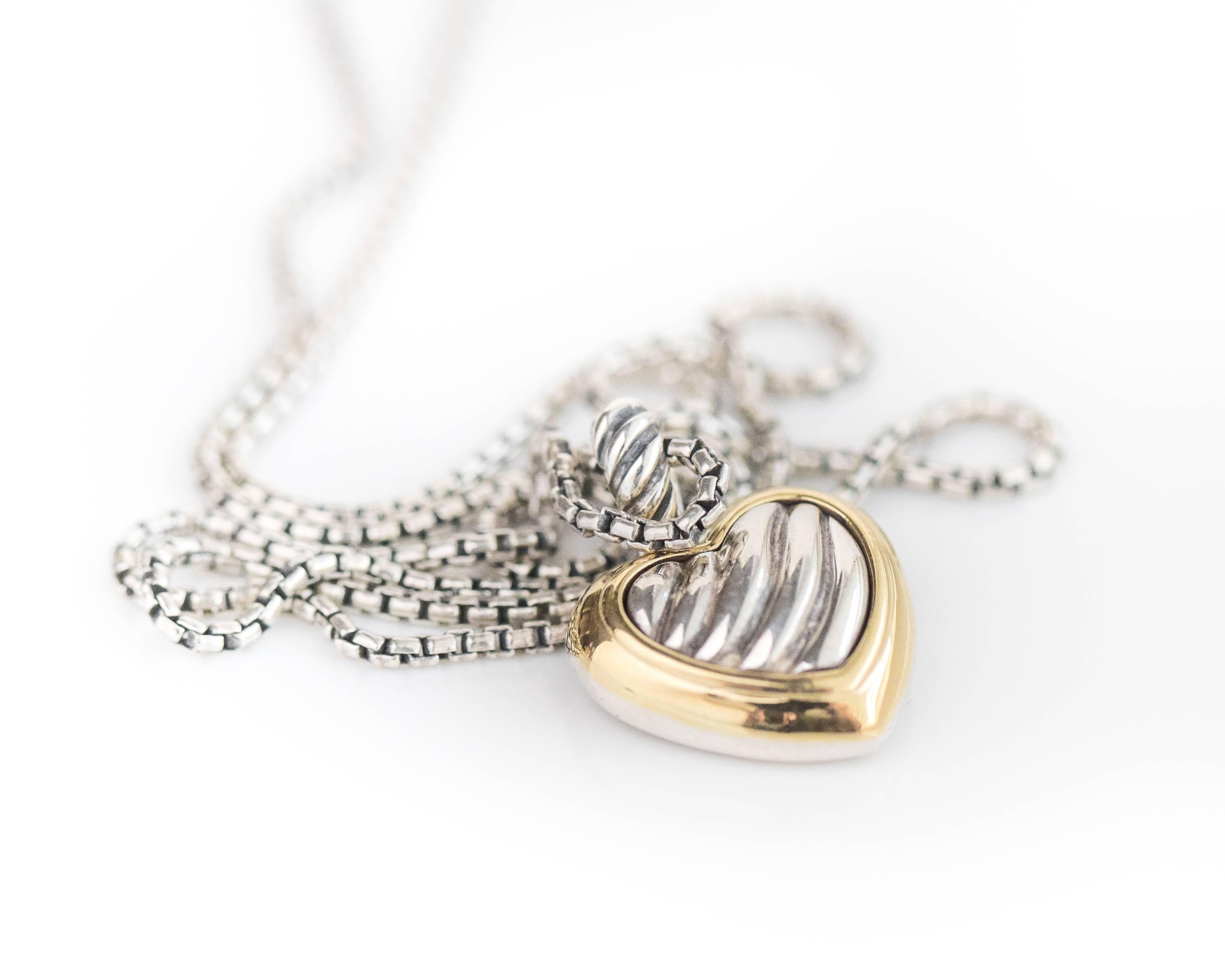2005 David Yurman Cable Heart Pendant Necklace features a sterling silver cable heart framed in 18 karat yellow gold. The puffed-front heart pendant is suspended by a cable bail on a 1 millimeter mini box chain with Lobster Claw clasp. The necklace