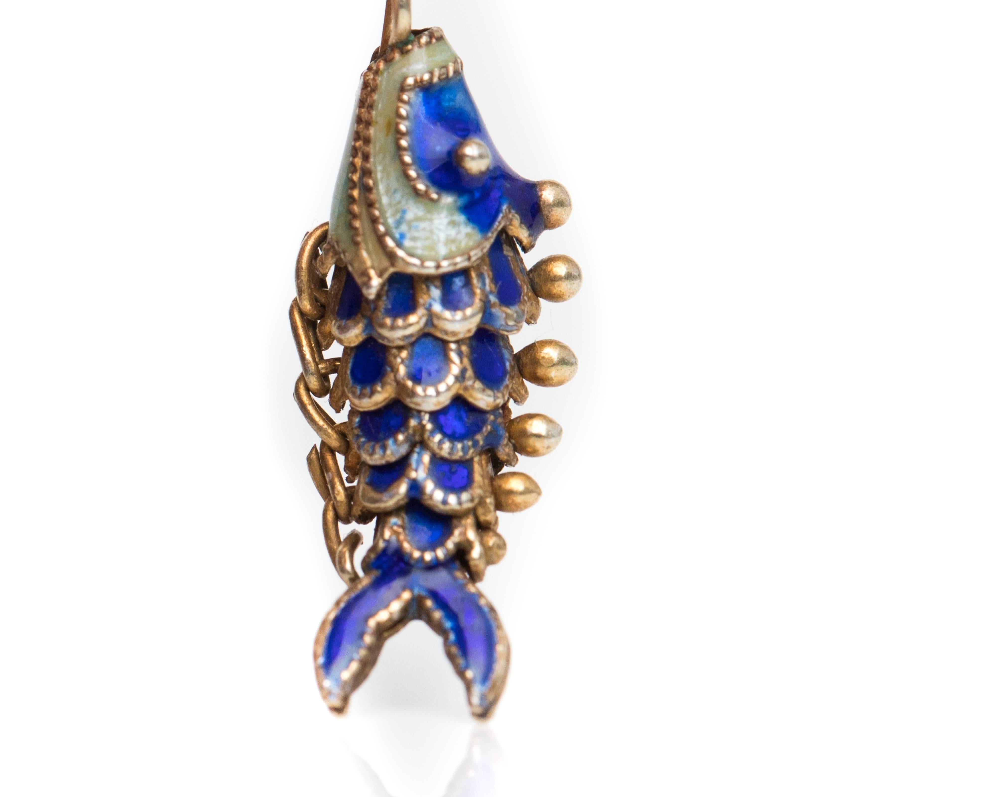 1930s Retro Enamel, 14K Yellow Gold Koi Fish Charm. Features an Articulated Koi Fish in Blue and opalescent White Enamel. The Koi Fish has 6 linked segments which allow movement simulating a swimming effect. The head is blue with white gills and