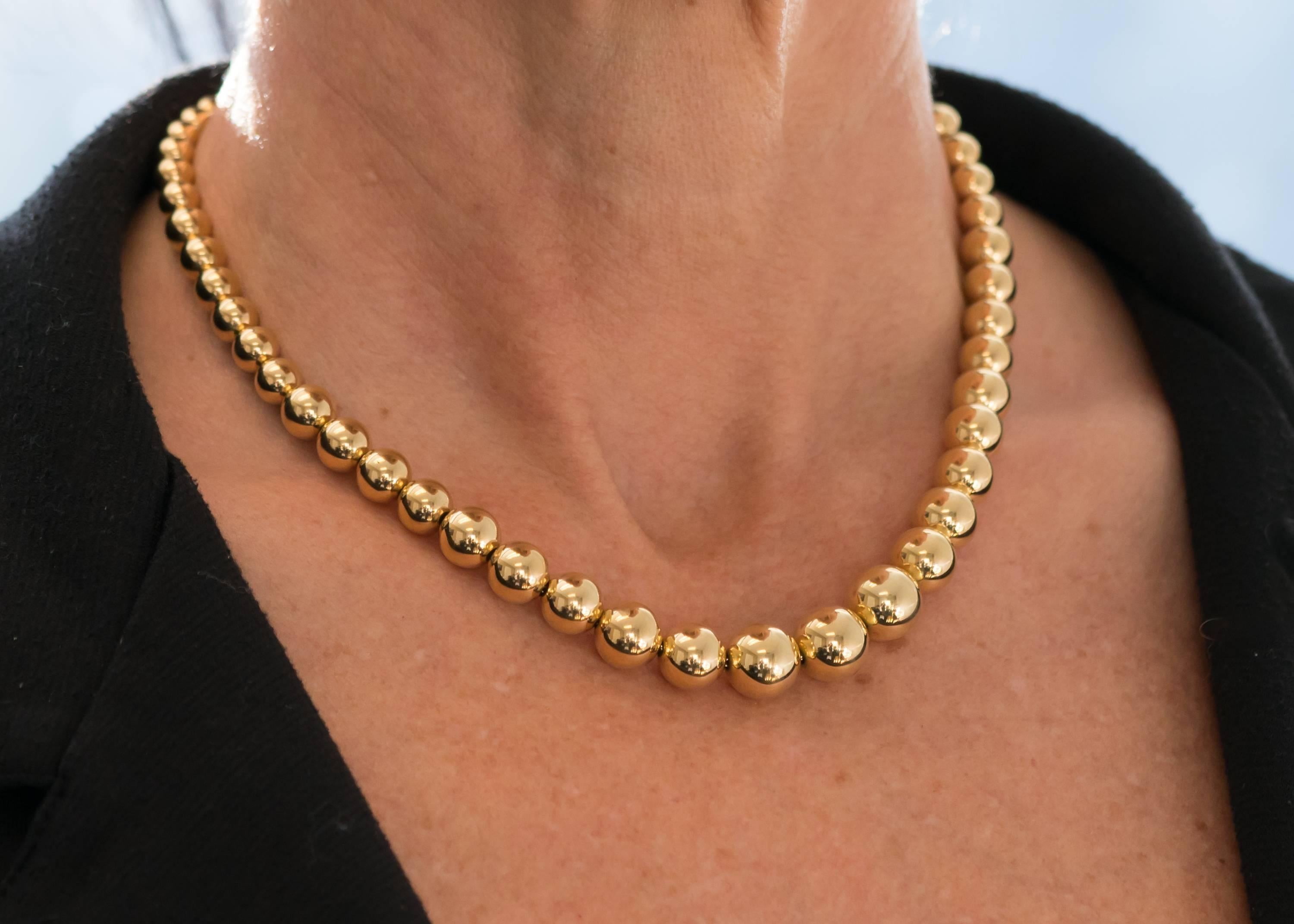 1960s Tiffany and Co 18K Yellow Gold Bead Necklace. Features 18K Gold, individually strung, highly polished beads on an 18K Gold rope twist Chain. The beads graduate in diameter from 6.1 millimeters in the back to 11 millimeters at the front center.