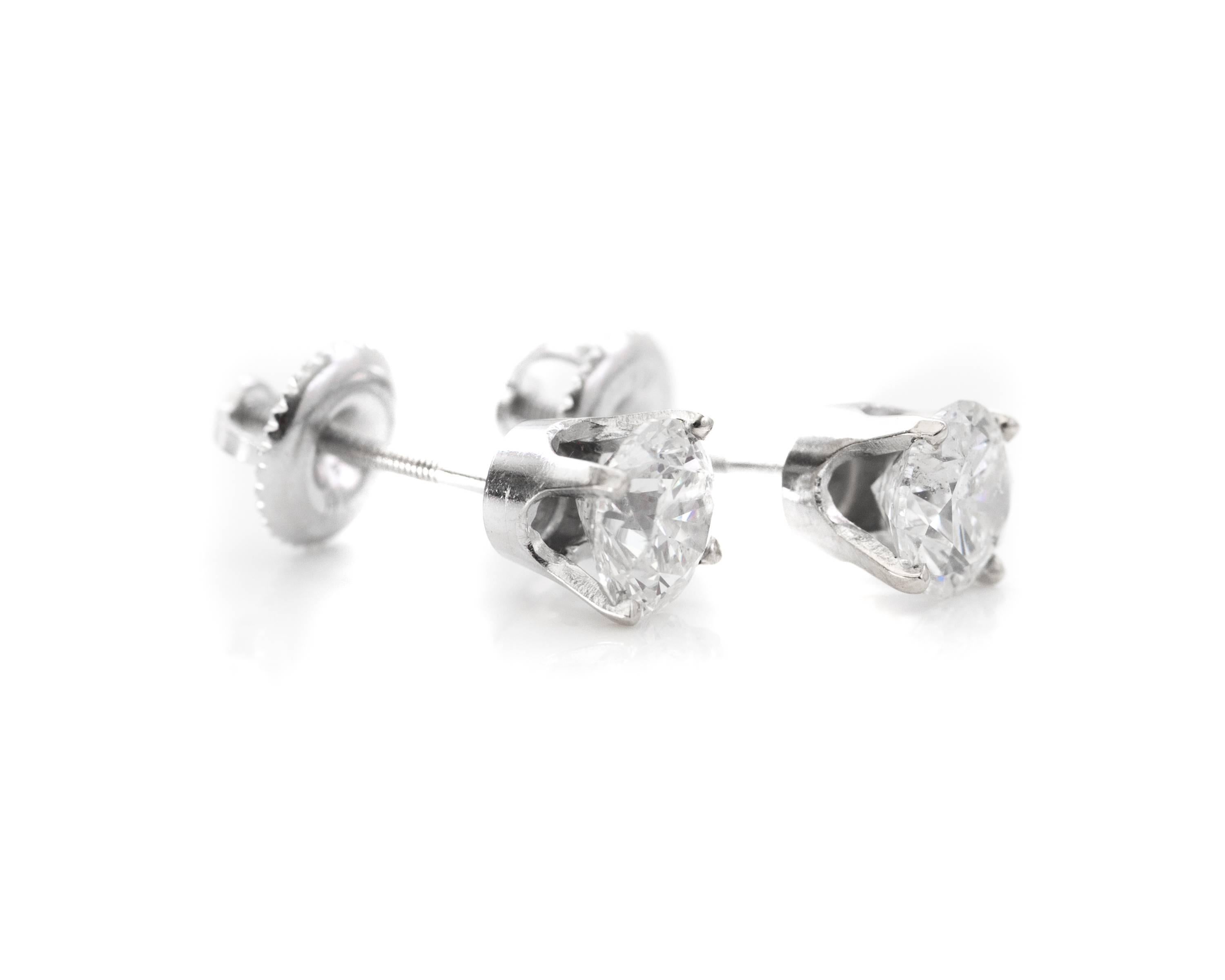 1960s 14K White Gold, Diamond Stud Earrings.

Feature:
 Screw Back Posts
 5.7 millimeter Round Brilliant Diamonds in 4-prong setting. 
Each Diamond weighs .75 carats for a 1.5 carat total weight for the pair. 
The diamonds have no visible