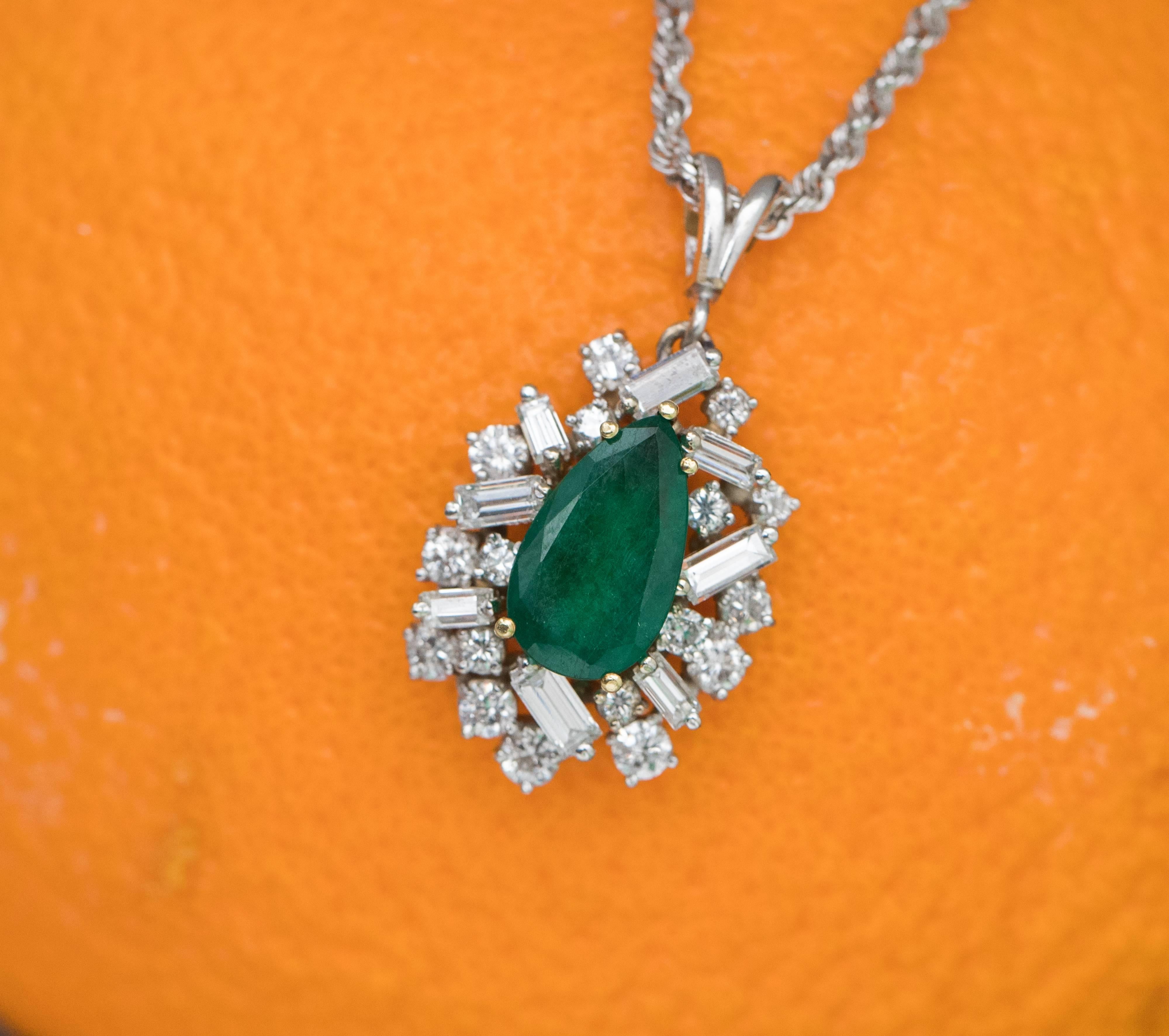 1960s Retro Emerald with Diamonds and 14K White Gold Necklace. 
Features a 2.5 carat Tear Drop Shaped, Dark Forest Green Emerald mounted in 14K Yellow Gold. 
Baguette and Round Brilliant Diamonds set in 14K White Gold surround the Emerald. 
A double