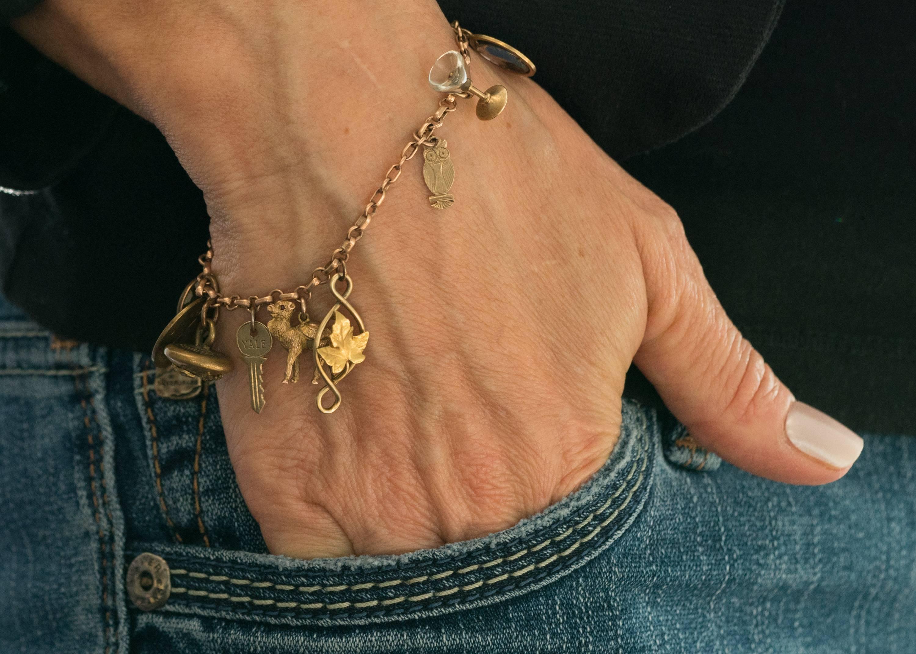 1890s Victorian Charm Bracelet with 12 Charms, 9K and 14K Yellow Gold. This darling charm bracelet features 12 distinctive charms:

1.  Teapot with Removable Lid - 14 Karat Yellow Gold
2.  Coral Lipstick in Tube
3.  Amethyst Cabochon 