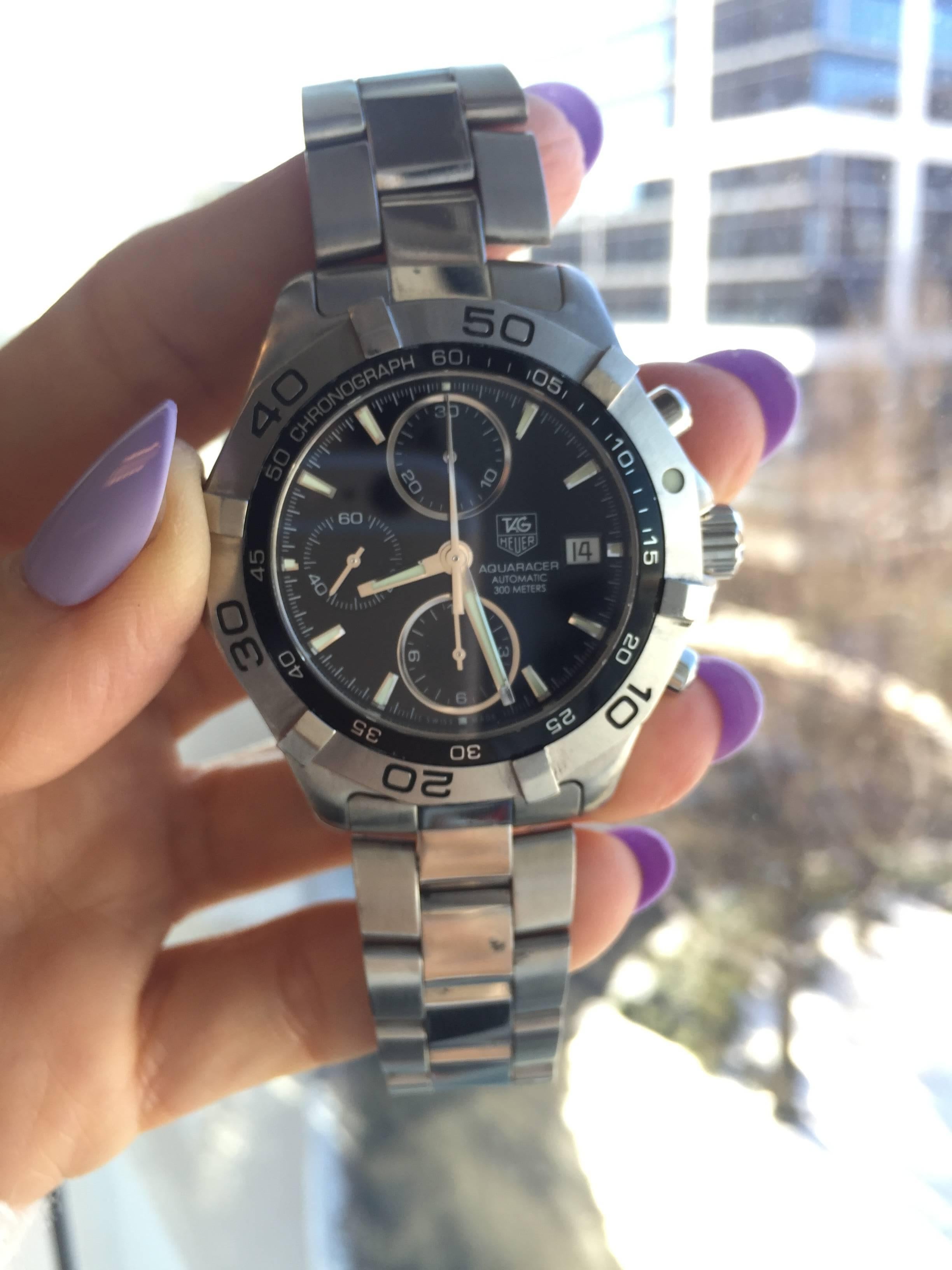 2014 Tag Heuer 2000 Aquaracer Chronograph 41 mm Watch with Stainless Steel Bracelet. This Ultra Accurate Watch features a Black Dial with Luminous Stick Hands and Hour Markers, Rotating Stainless Steel Bezel, 
3 sub-dials for 60 seconds, 30 minutes