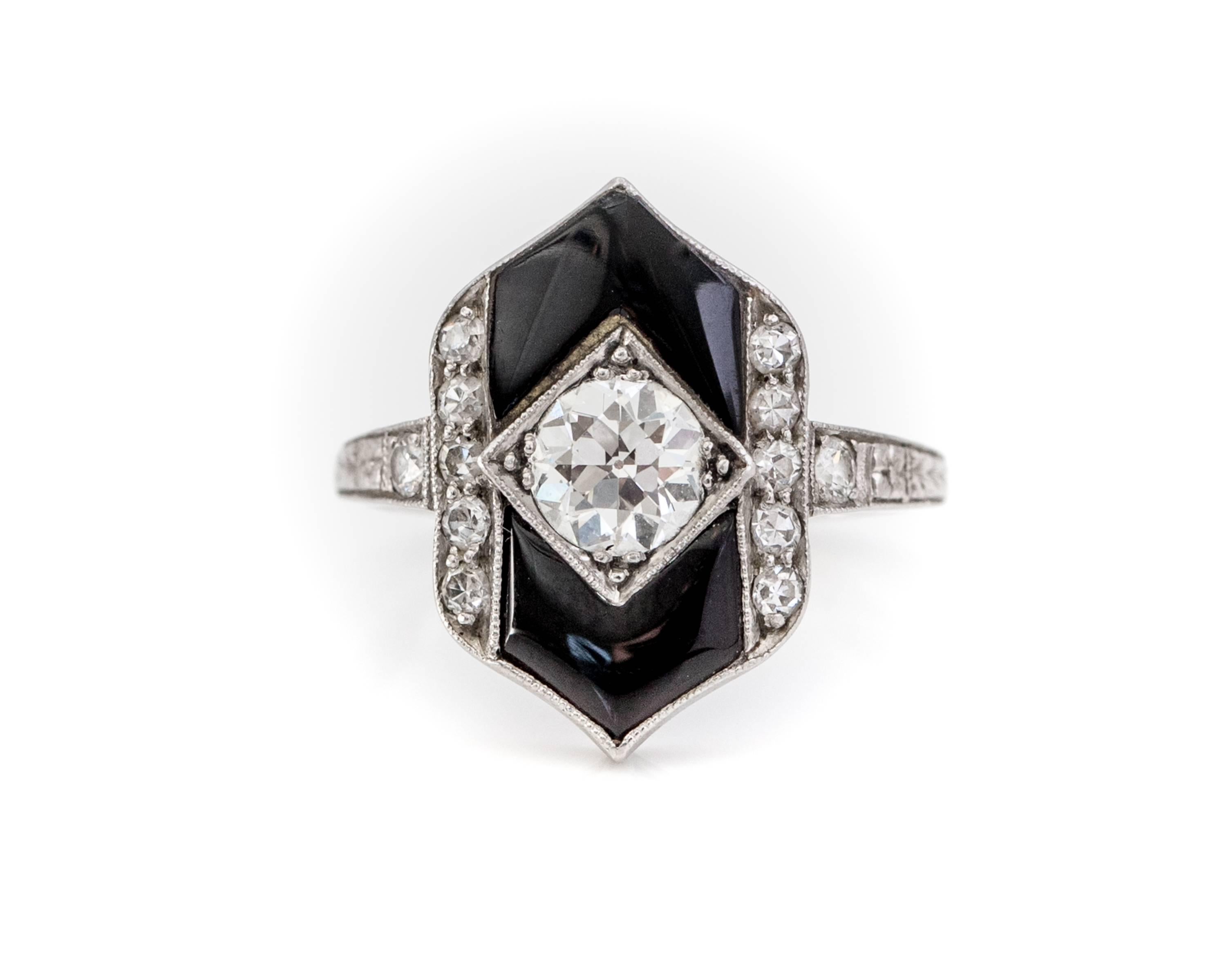 1930s Art Deco Ring. This Stunning Ring exemplifies Art Deco style, Geometric Design in Contrasting Colors.

Features a .60 carat Old European Center Stone in an 8 prong setting, framed by highly polished Black Onyx. Two 5-Diamond vertical columns