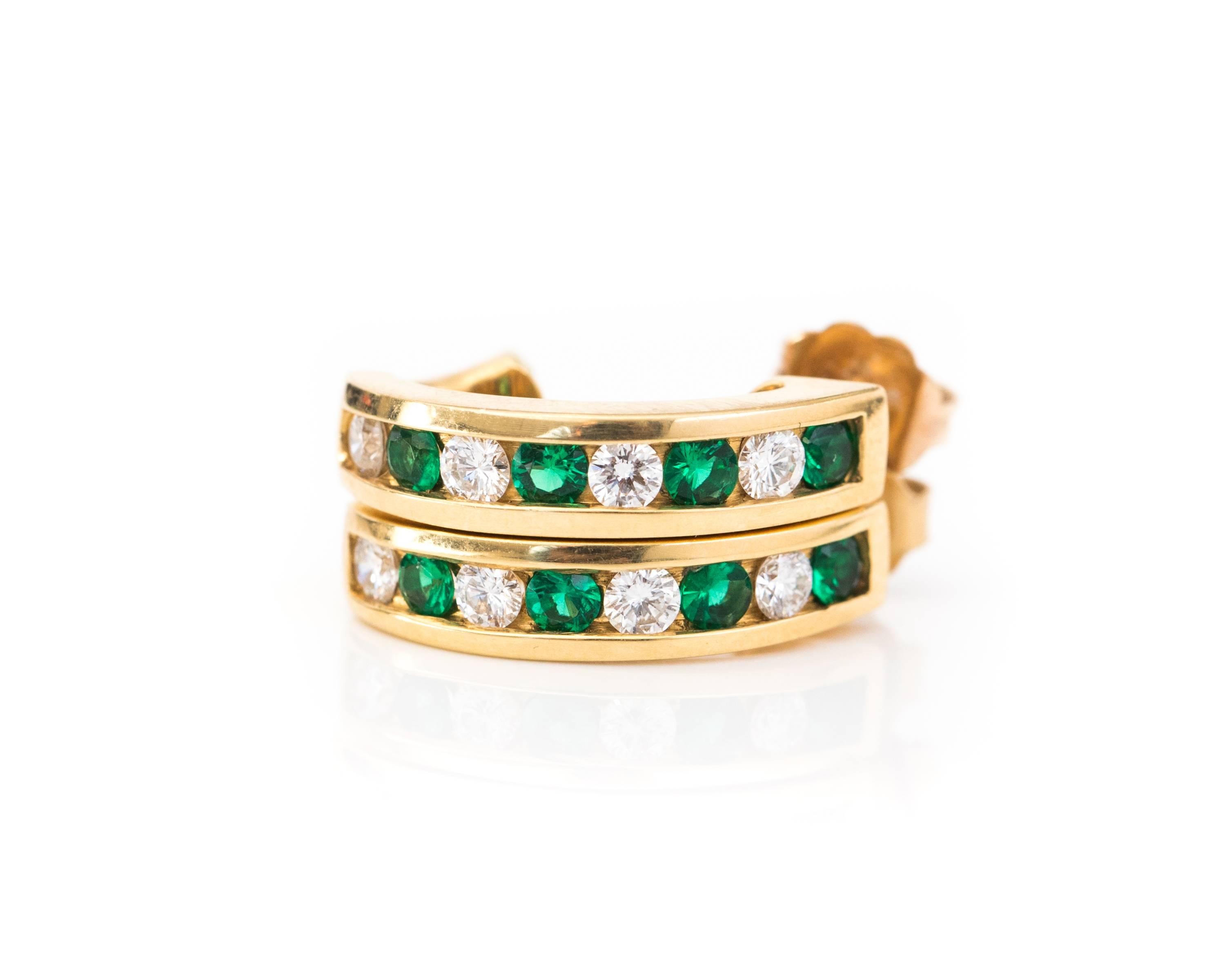 1990s Tiffany and Co. 18 Karat Yellow Gold, Diamond and Emerald Hoop Earrings. 

Features .70 cttw Diamonds and .70 cttw Emeralds. Each earring holds 4 Emeralds and 4 Diamonds channel set in an alternating pattern beginning with an Emerald at the