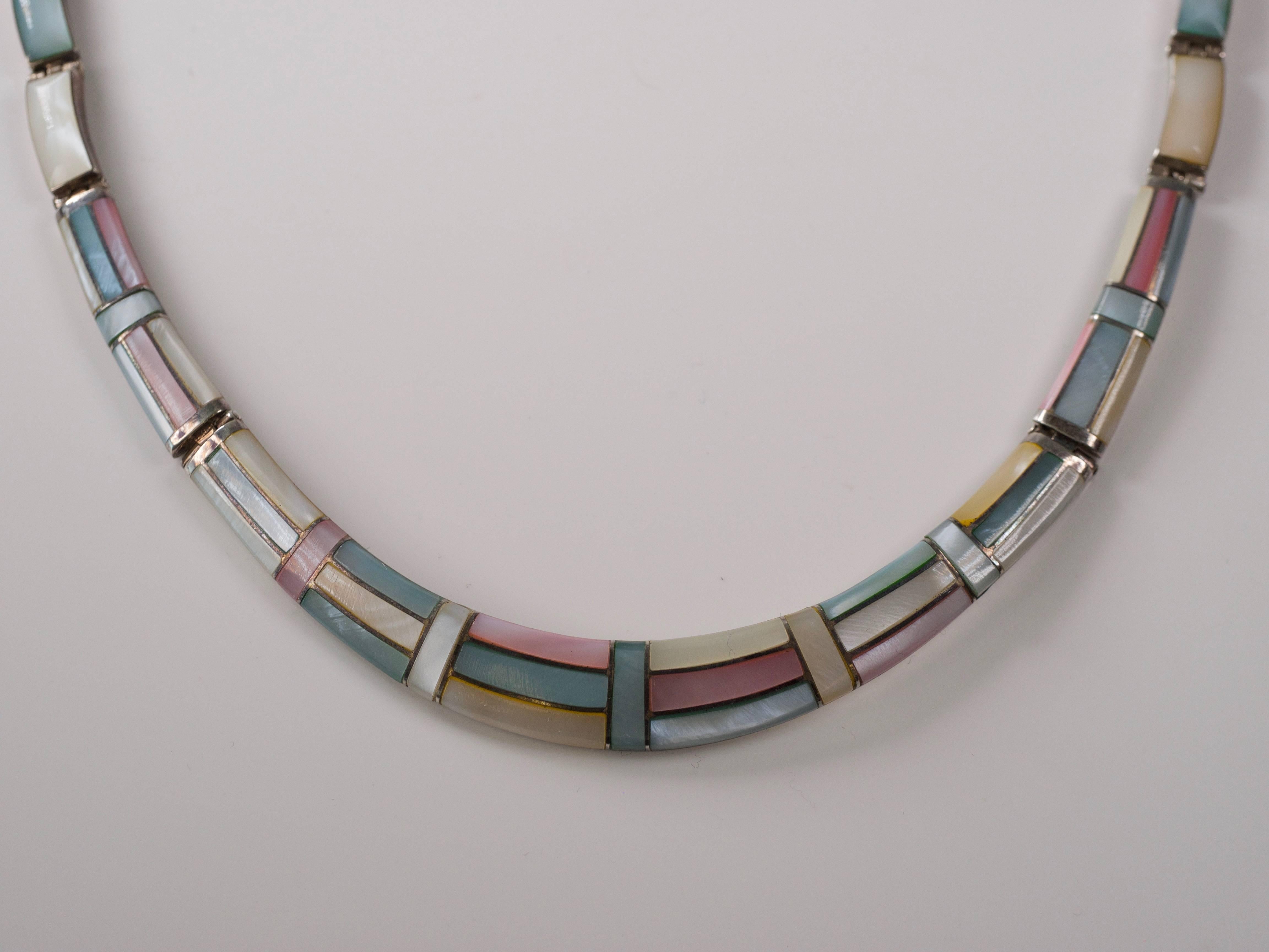 1950s Natural Pastel Shell Inlay with .950 Sterling Silver necklace.

Features Pastel Pink, Light Blue, White and Winter White polished shell inlaid in Sterling silver. The Geometric pattern accentuates the color play and opalescence of the