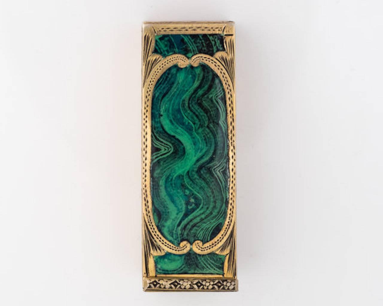 1940s Lipstick Case features a Mirror, crafted in Malachite and Sterling Silver.

This Ornate hand-etched piece has a lovely matte malachite finish on the top of the case. The malachite is a bright green hue swirled with darker shades of green. And