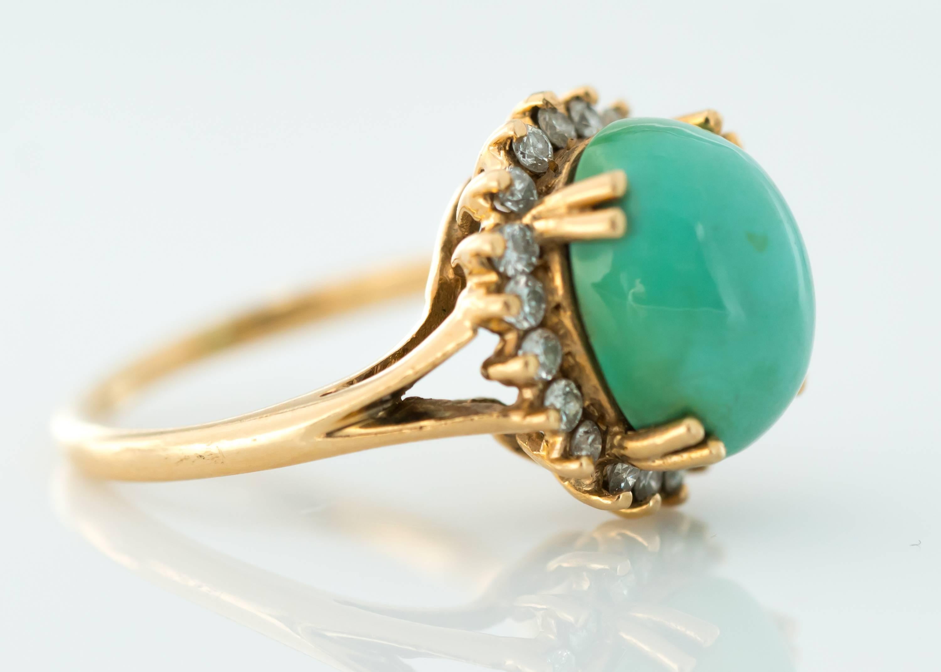 Tiffany and Co. Persian Turquoise Cabochon, Diamond Halo and 14 Karat Yellow Gold Ring

Features a 12 millimeter by 10 millimeter Persian Turquoise Cabochon securely set with 4 double prongs. A Diamond Halo frames the stunning center stone.