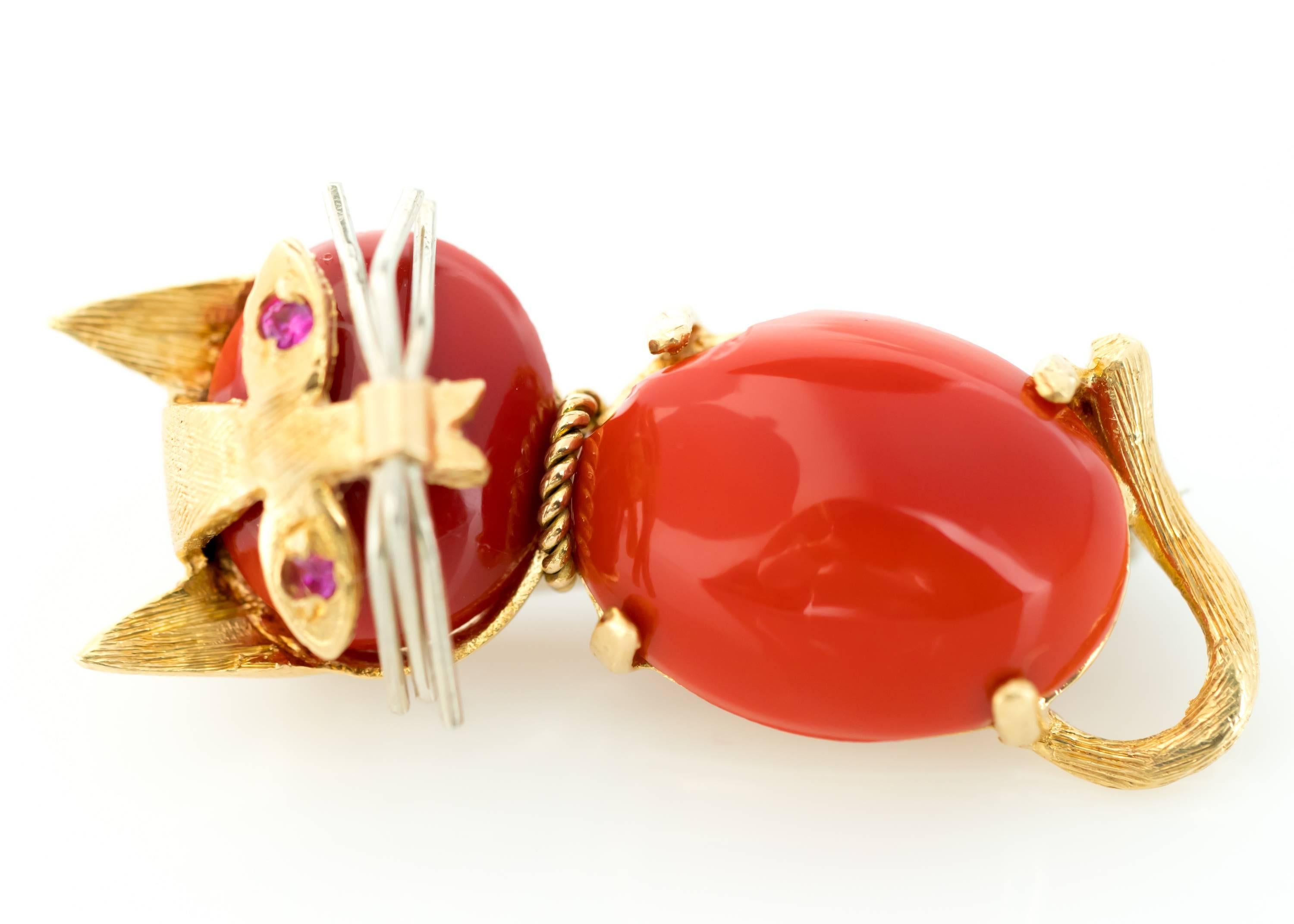 1960s Coral Cat Brooch with Ruby Eyes and 18 Karat Gold

Features 2 Ruby Eyes, Coral Head and Body and 18 Karat White Gold Whiskers. 18 Karat Yellow Gold frames the head and body and adds facial marking details to the face. The Tail, Ears, 4 tiny