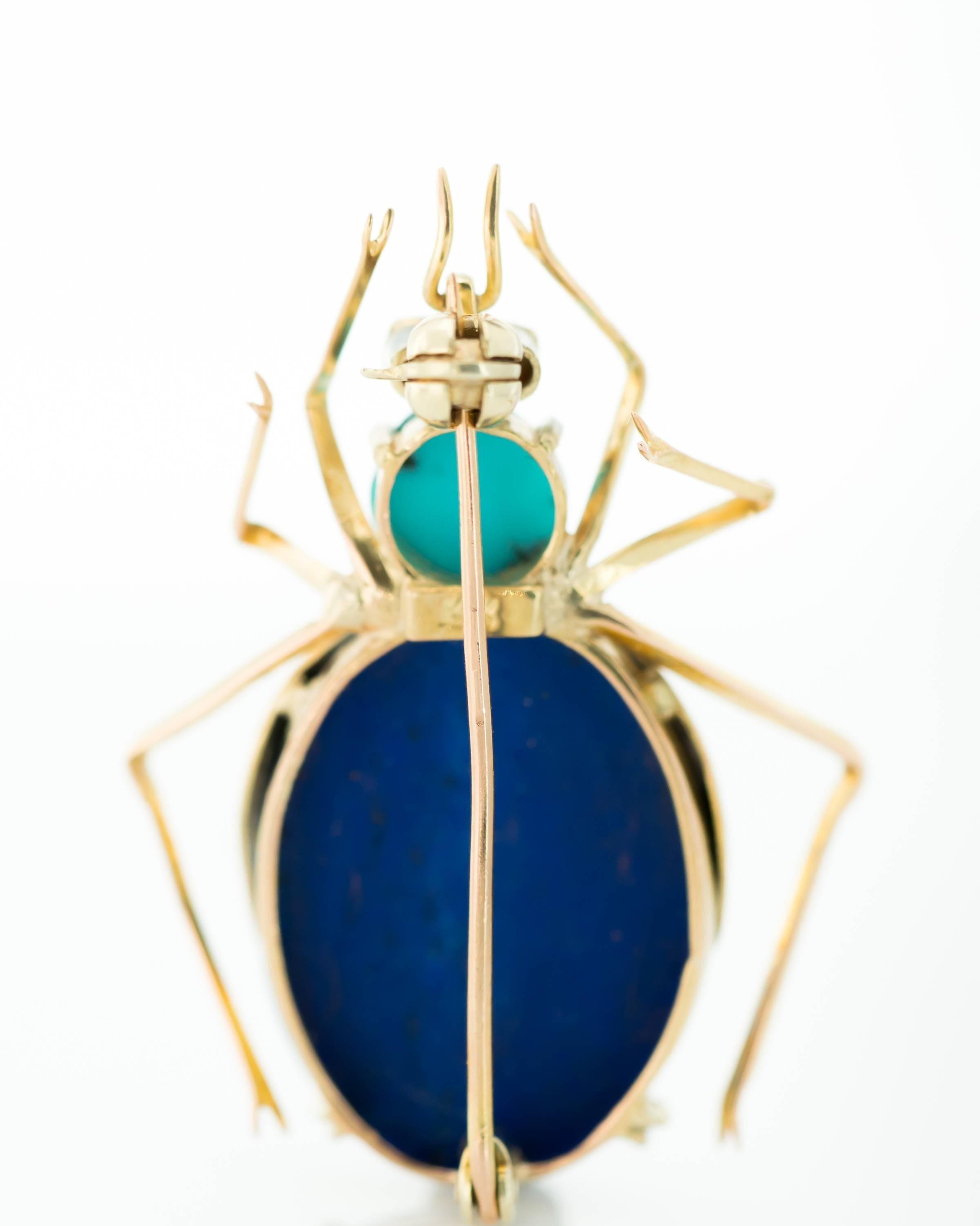 1950s Insect Brooch - Lapis Lazuli, Turquoise, Ruby, 14 Karat Yellow Gold

Features an Oval Lapis Lazuli Cabochon Body, Turquoise Head and 2 Ruby Eyes. 14 Karat Yellow Gold frames the body and forms the 2 Wings, 6 Legs and 2 Pincers. The deep blue