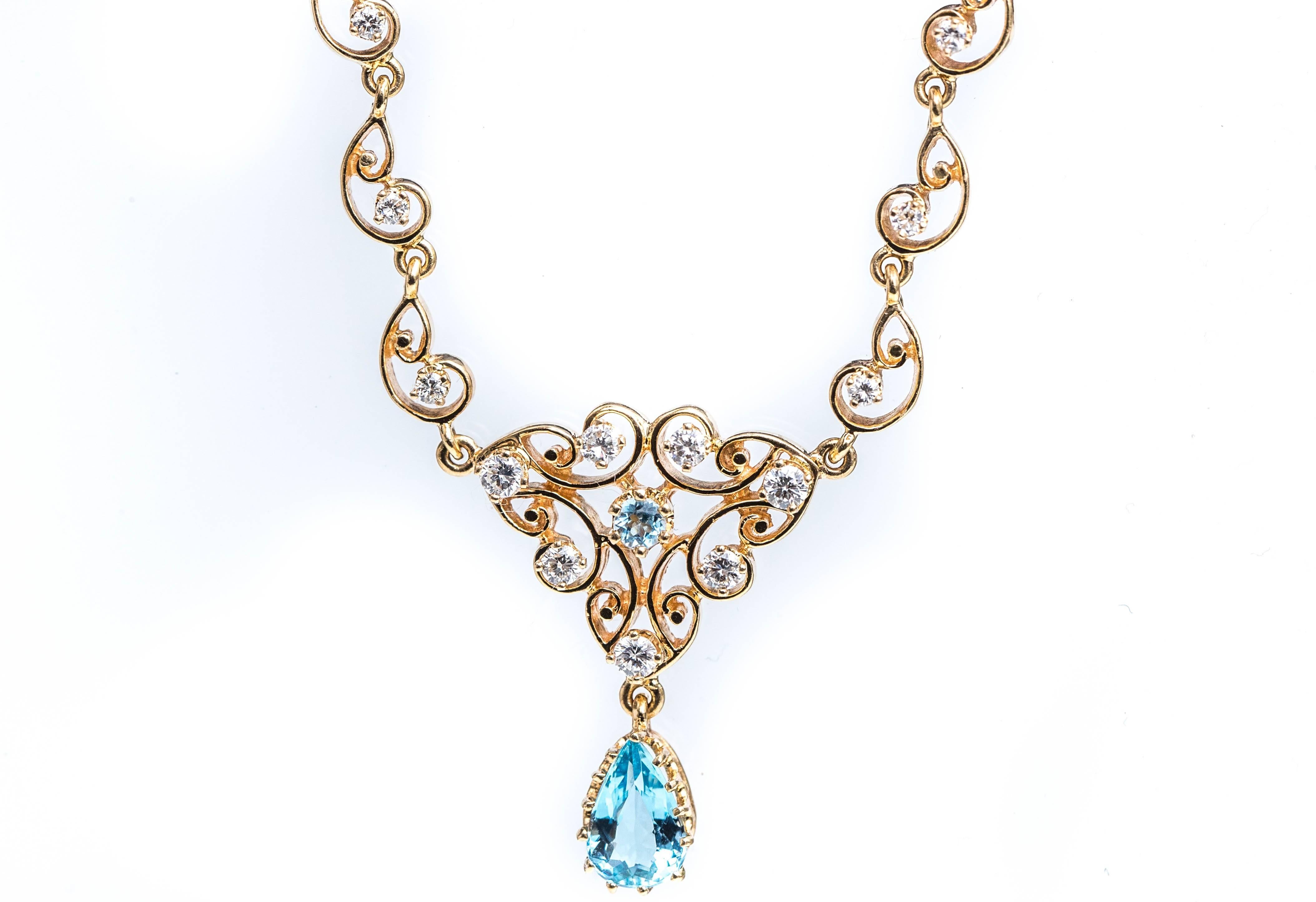 1950s Aquamarine, Diamond and 14 Carat Yellow Gold Necklace

Features a Victorian style-inspired design, 13 Round Brilliant Diamonds and a Pear shaped Aquamarine Charm. 

The V-shaped necklace center piece has a center set, round Aquamarine