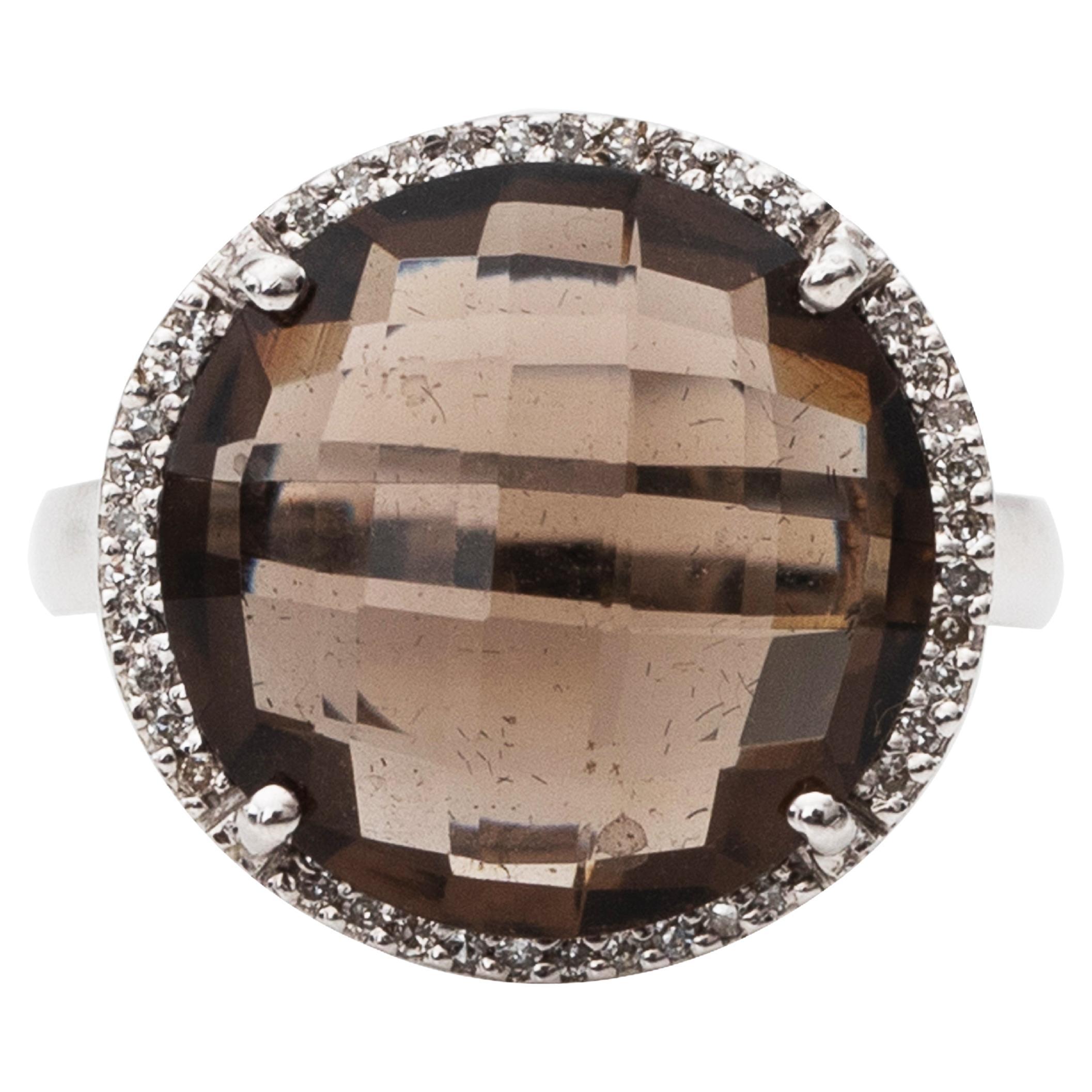 Item Details:
Metal type: 14 Karat White Gold
Weight: 5.8 grams
Size: 6 (resizable)

Smokey Quartz Details:
Cut: Fantasy Cut
Carat 4 Carats 

A beautiful, ornate ring from the 1980s. It features a beautiful 4 Carat Smokey Quartz in the Center, which