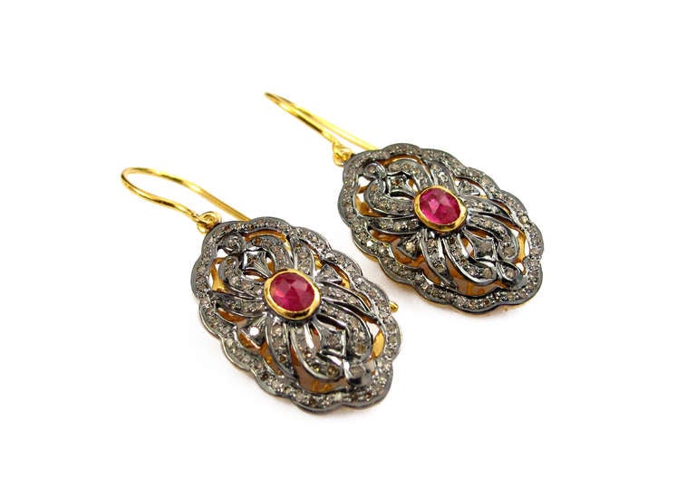 These show stopping modern earrings contain a 0.55 carat Ruby and 10.7 carats of Diamonds. Set in to 18K Yellow gold with Black Rhodium Plating, these earrings are modern and edgy as well as being classic signature pieces.