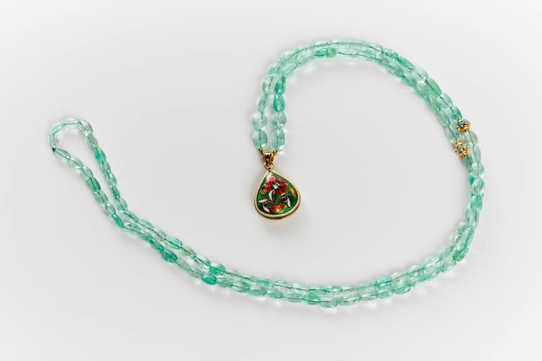 Emerald Beads Necklace Adorned With Small Gold Charms and Polki Diamond Pendant.  18k Gold.
Emerald 140 ct.