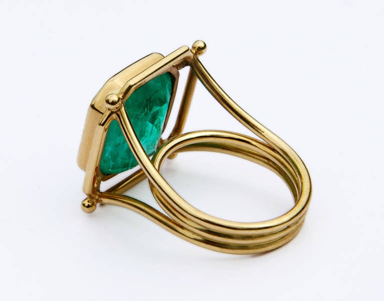 A Show Stopping Emerald Delicately Framed in 18k Yellow Gold Minimalist Ring. 
Emerald 11 ct