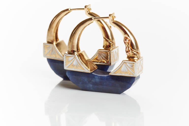 Hand Carved Blue Sapphire Hoop Earrings Set in 18k Yellow Gold With Intricate White Enamel Work. 
Sapphire 31 ct.