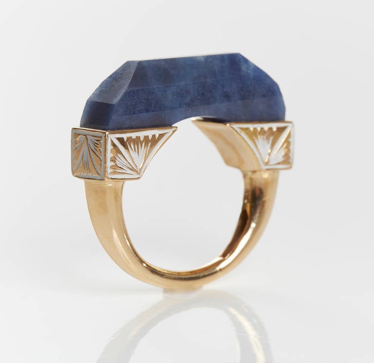 Hand Carved Blue Sapphire Ring Set in 18k Gold Band With Intricate White Enamel Work. 
Sapphire 18.80 ct.
This Piece Can be Worn as a Pendant on an 18 Inch 18k Gold Chain.  
Price With Chain- $3,760.