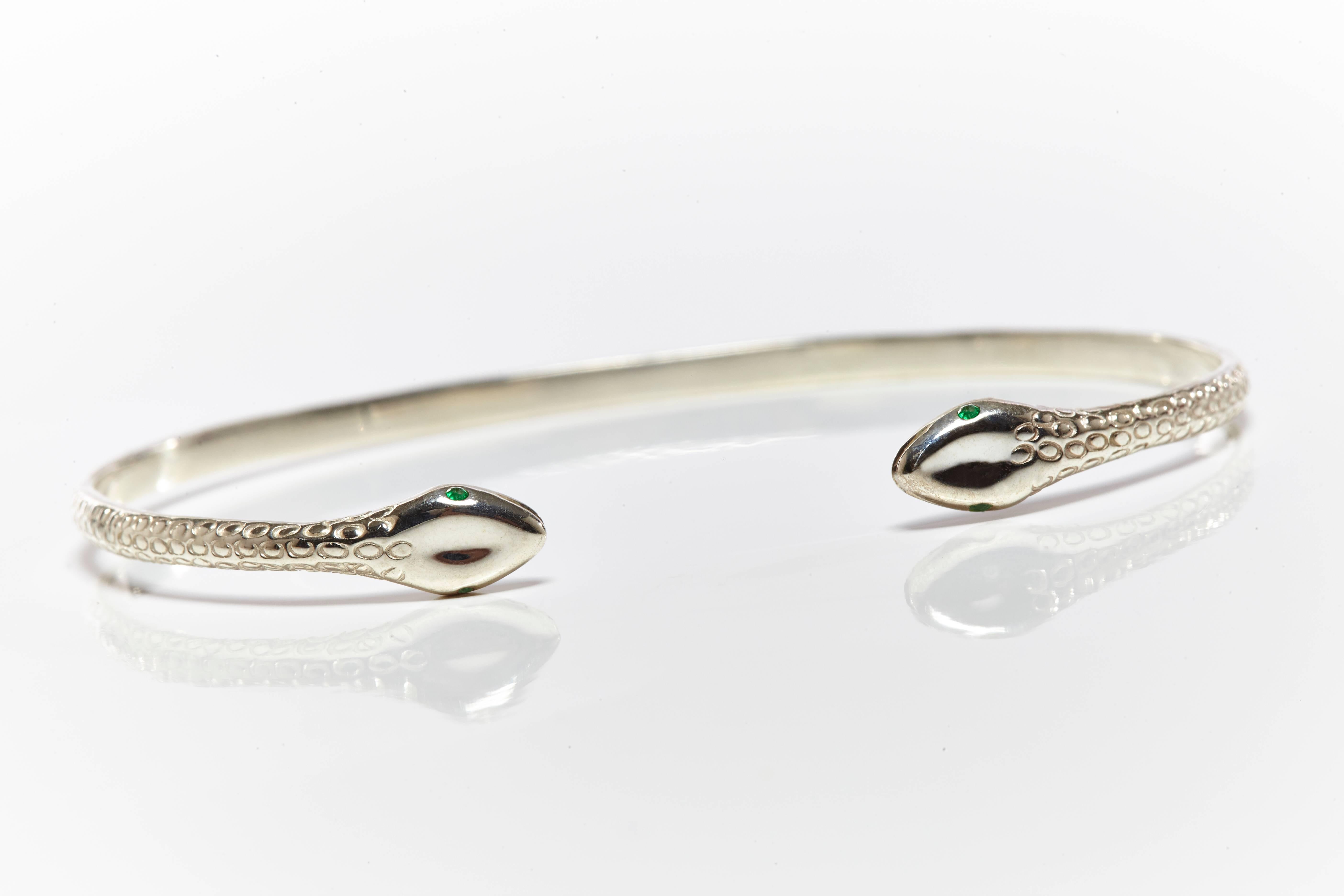 Silver bangle featuring cobra with emerald eyes from Jade Jagger Snake collection.
Size free.
Handmade in India.
Also available with diamond.