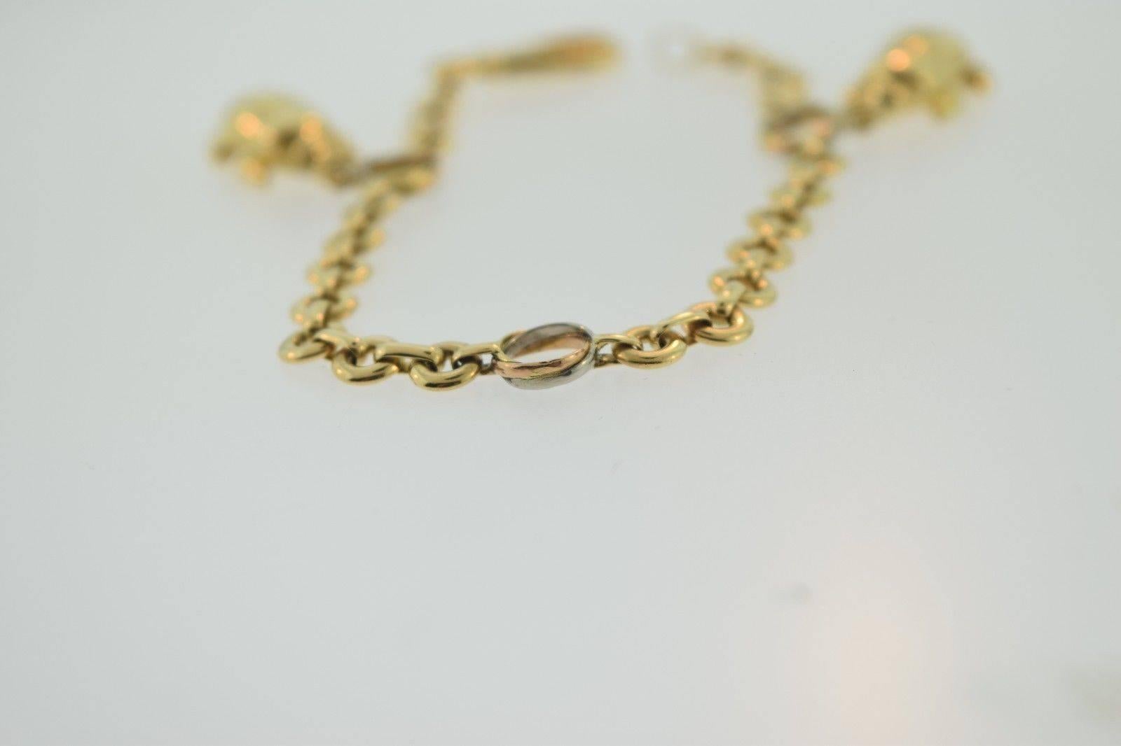 Cartier Scarab Three Color Gold Trinity Charm Bracelet In Excellent Condition For Sale In Miami, FL