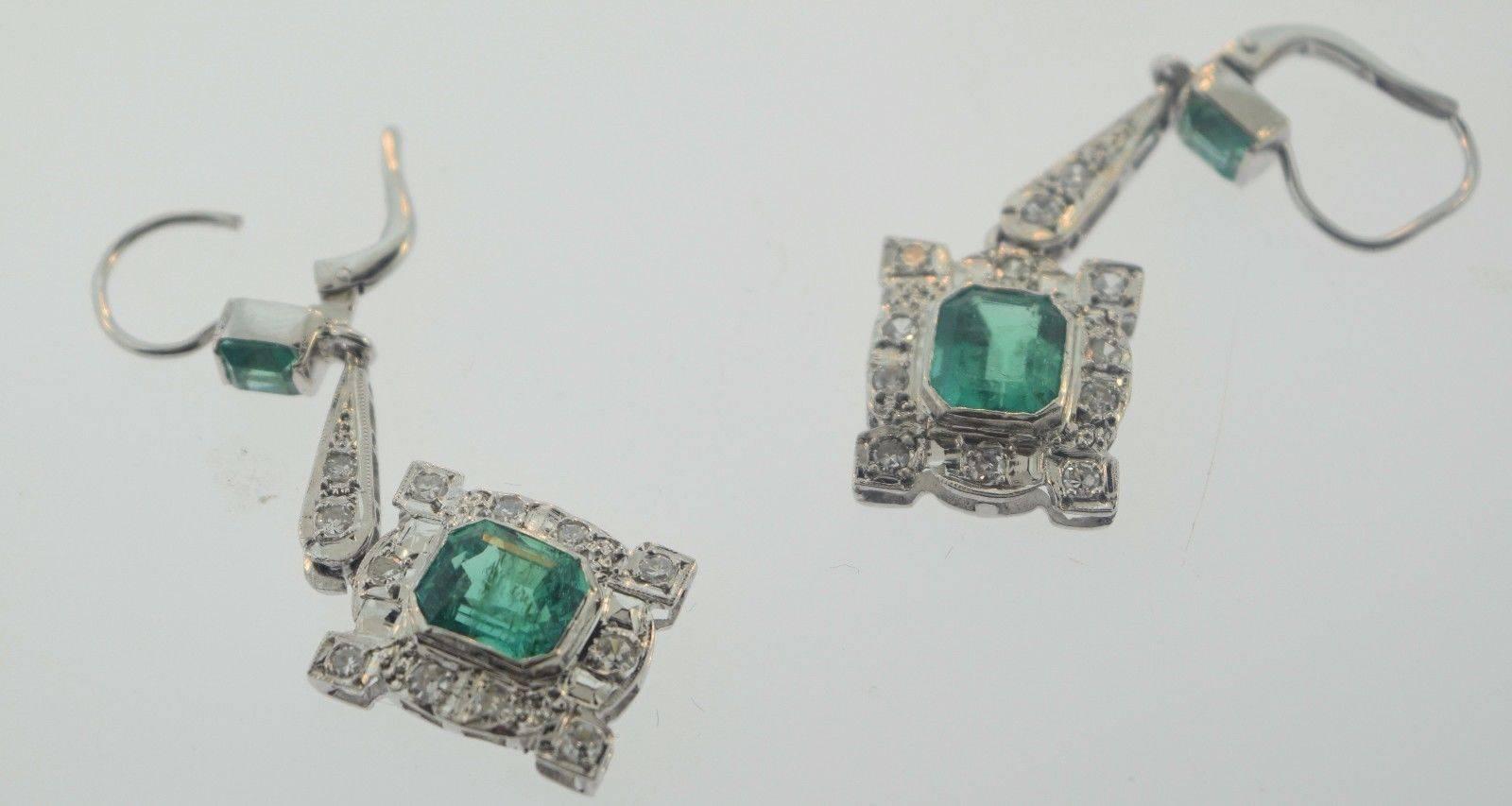 About the Item:
These delightful drop earrings feature elegant 8.25 x 7.30mm rectangular shaped Emerald gemstones suspended from 3.75x3.47mm rectangular shaped Emerald gemstones with sparkling 1.5 carat total weight Diamond accents all around. Set