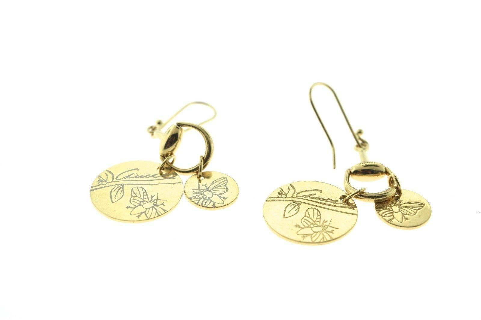 About the Item:
Fabulous Horse-bit charm necklace, bracelet, and earrings 3 piece set made and signed by Gucci. Signature Gucci 18K yellow gold link 3 piece set each with round charms, beautifully engraved with butterflies and Irises from the