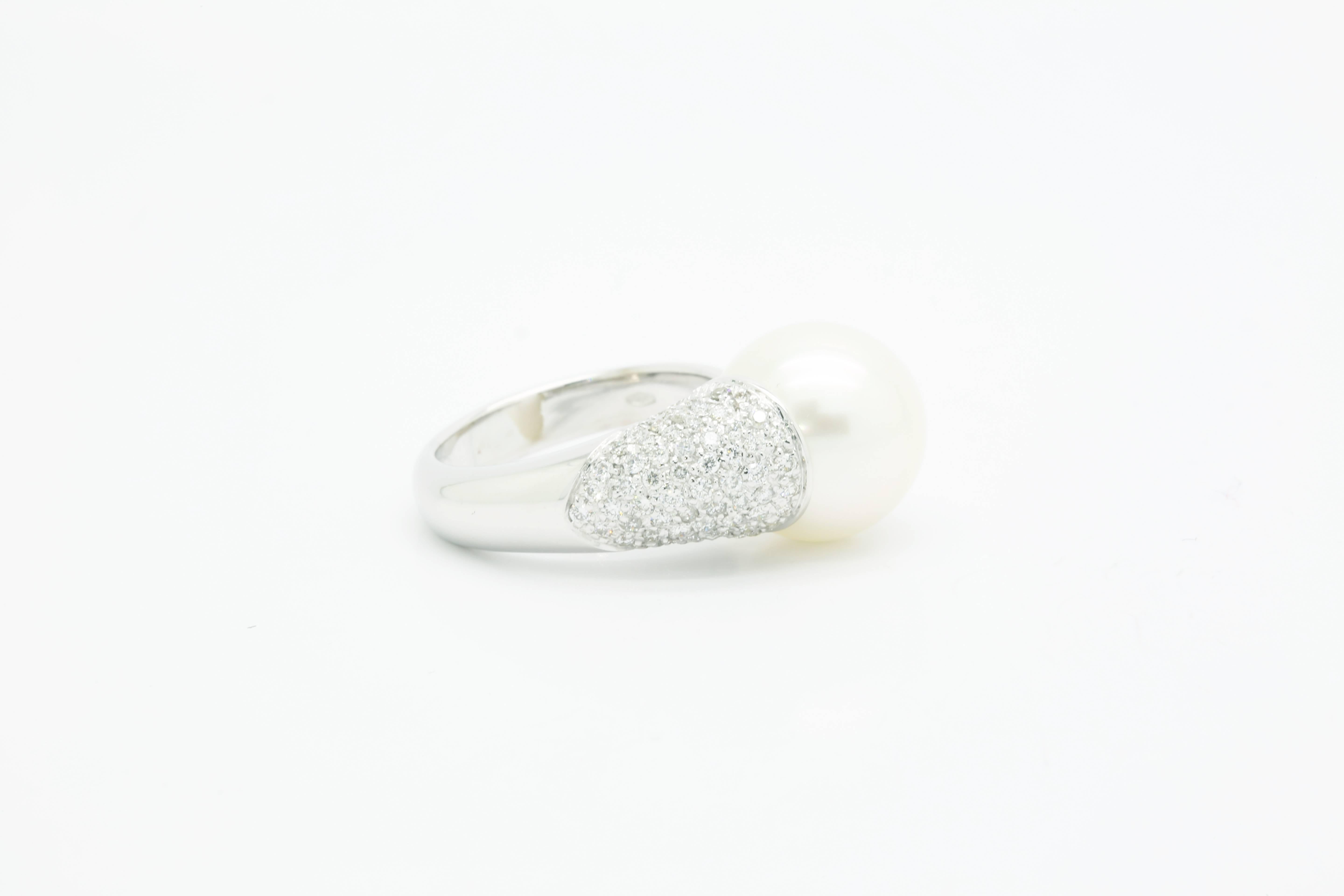 A white Australian pearl and white diamonds ring, FERRUCCI in a contemporary ring design to compliment the delicate unique class of a sophisticated woman, cherished as symbols of purity and perfection, elegance and affluence.

Entirely made in 18k
