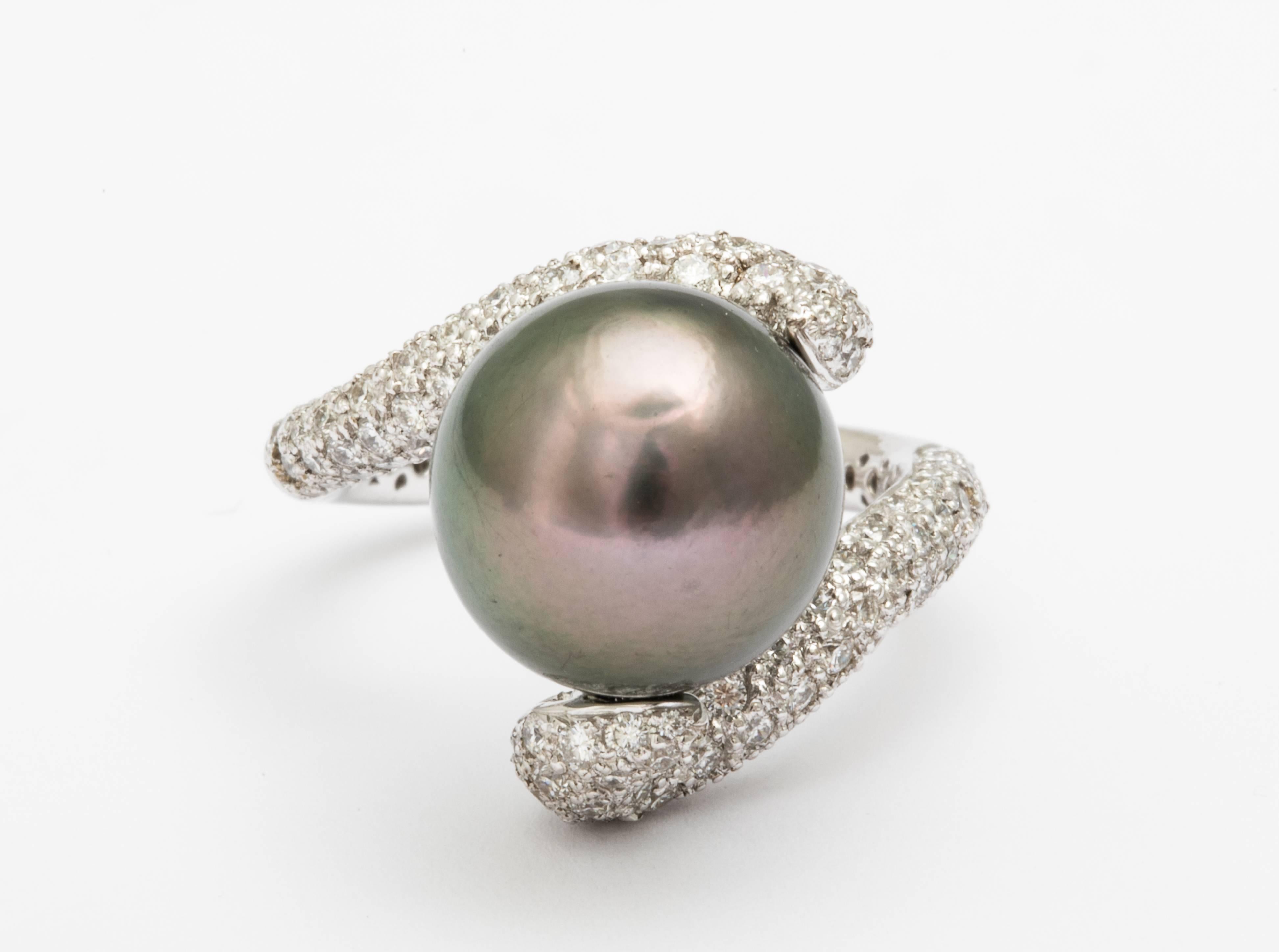 Natural Tahitian Pearl of 12 mm size, in an original design showcasing 1.68 carats of white diamonds hand set in a unique 18k white gold ring, hand made by FERRUCCI
