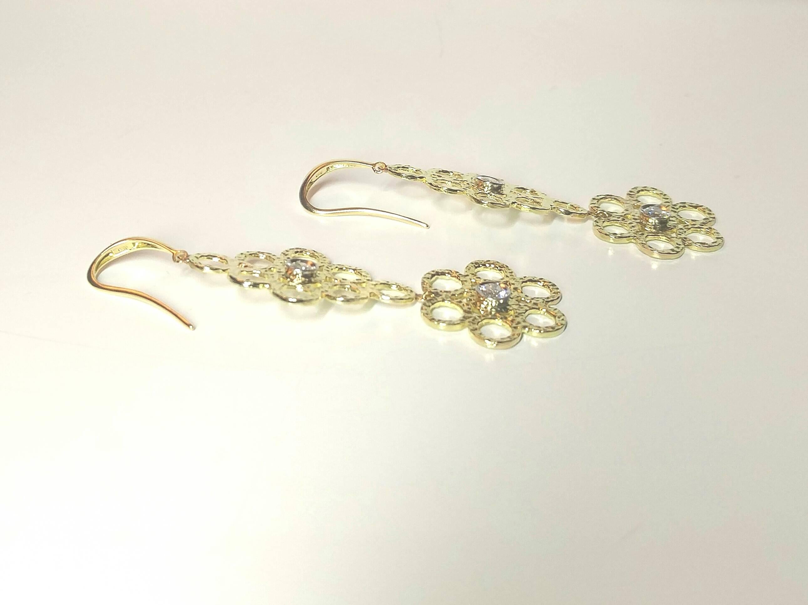 From Doria Studio Designs, "So Feminine", delicately designed large 18k gold earrings, showcasing a diamond total weight of 0.24 carats set in Platinum   

