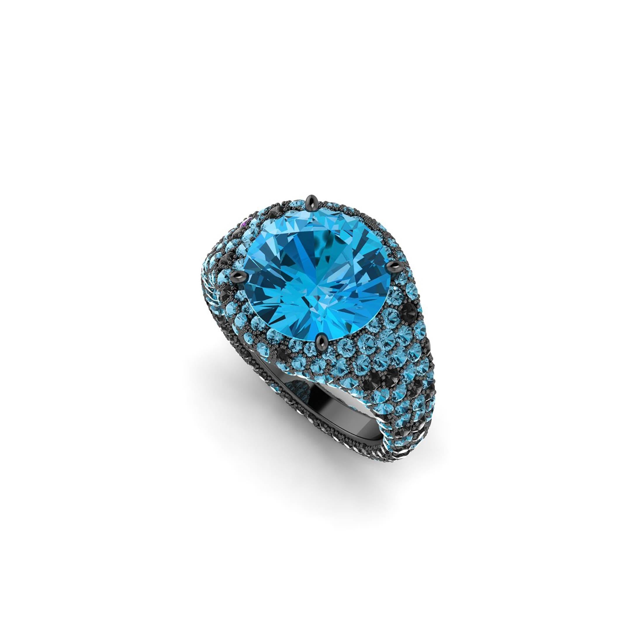 from FERRUCCI, approximately 4.50 carats intense blue round cut Topaz, adorned by approximately 2.00 carats of round blue Topaz melees pave' set and approximately 1.10 carats of round black diamonds, conceived in an 18k black gold couture