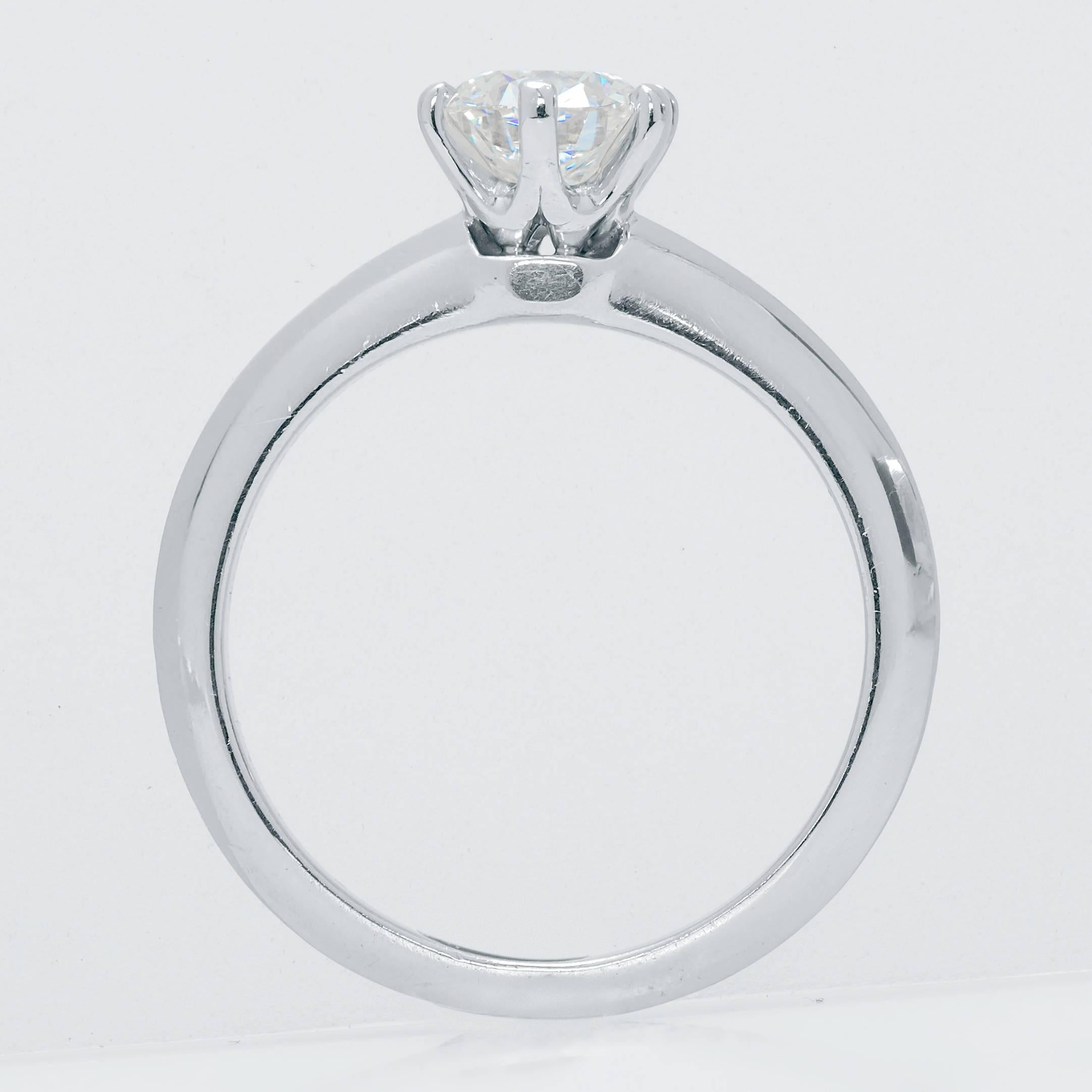 This Tiffany & Co. platinum solitaire ring is set with a 0.66ct round IVS1 diamond.  The ring fits finger size 4.5.  The platinum band has minor wear consistent with age that doesn't take away from the beauty of the piece.

This ring will come
