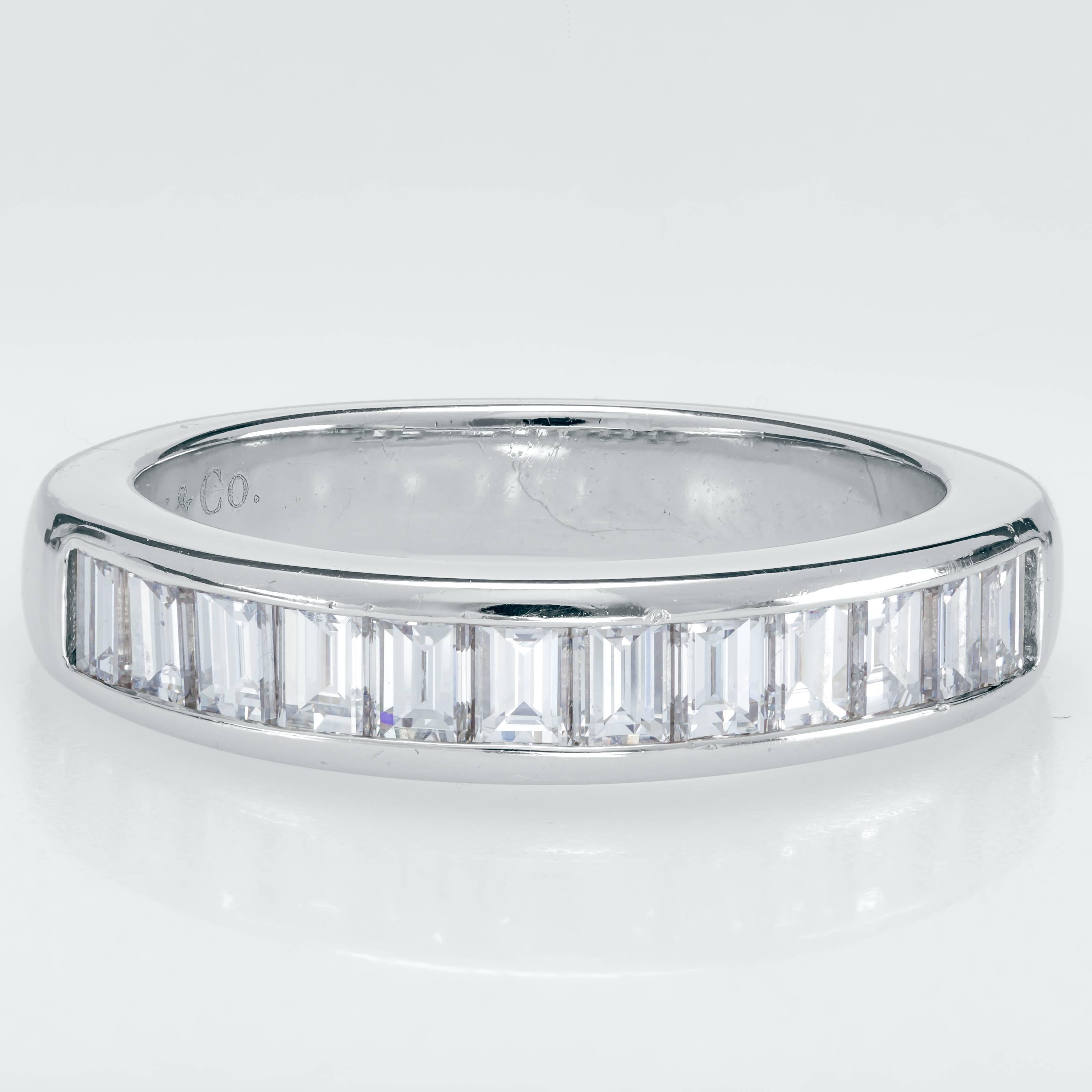 This Tiffany & Co. ring features 12 channel set baguette diamonds totaling 0.96ct set in a platinum band.  The round band measures 21mm diameter and 4mm thick.  It fits a finger size 6.  It has minor wear on the band and two very small marks by the