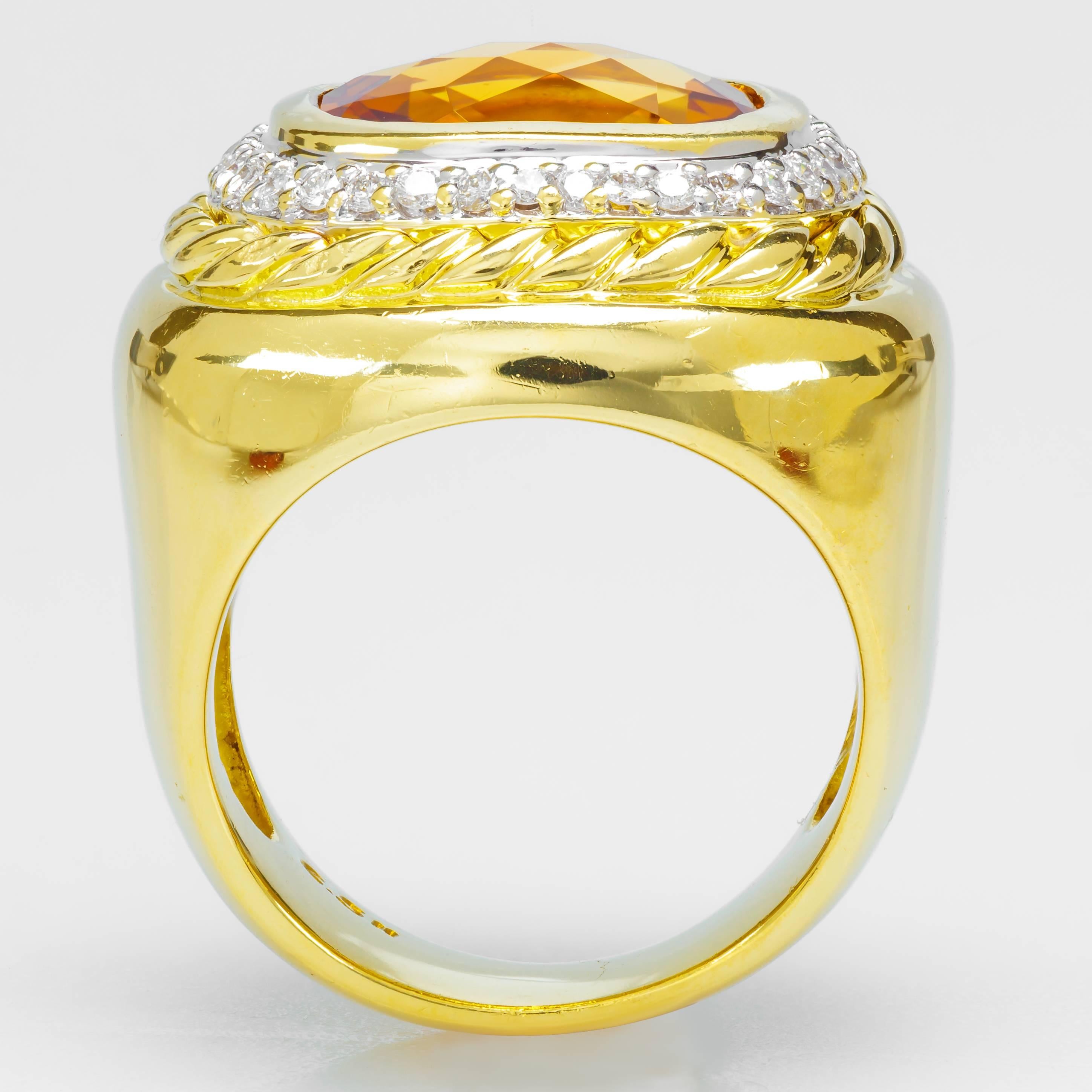 This 18k yellow gold and sterling silver David Yurman ring holds a bezel-set citrine and 38 round diamonds.  It features a smooth shank and a braided design. The inside of the band is stamped with 750 and the David Yurman signature.  It is a size