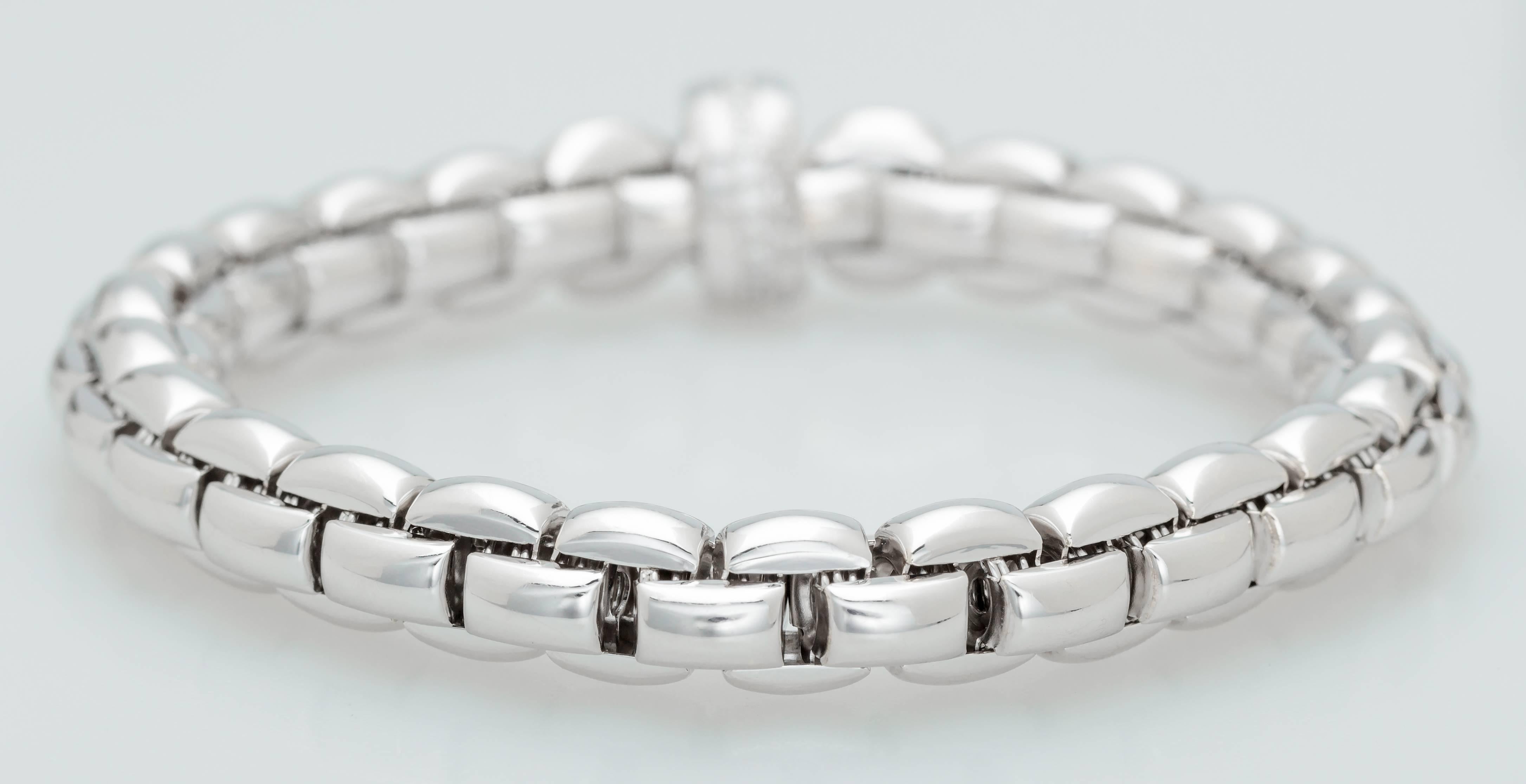 This Fope Flex It 18K white gold bracelet stretches to fit over your hand.  It has a rondel set with 23 diamonds totaling 0.21ct.  The bracelet fits a 15cm wrist.  The rondel measures 8mm in diameter.