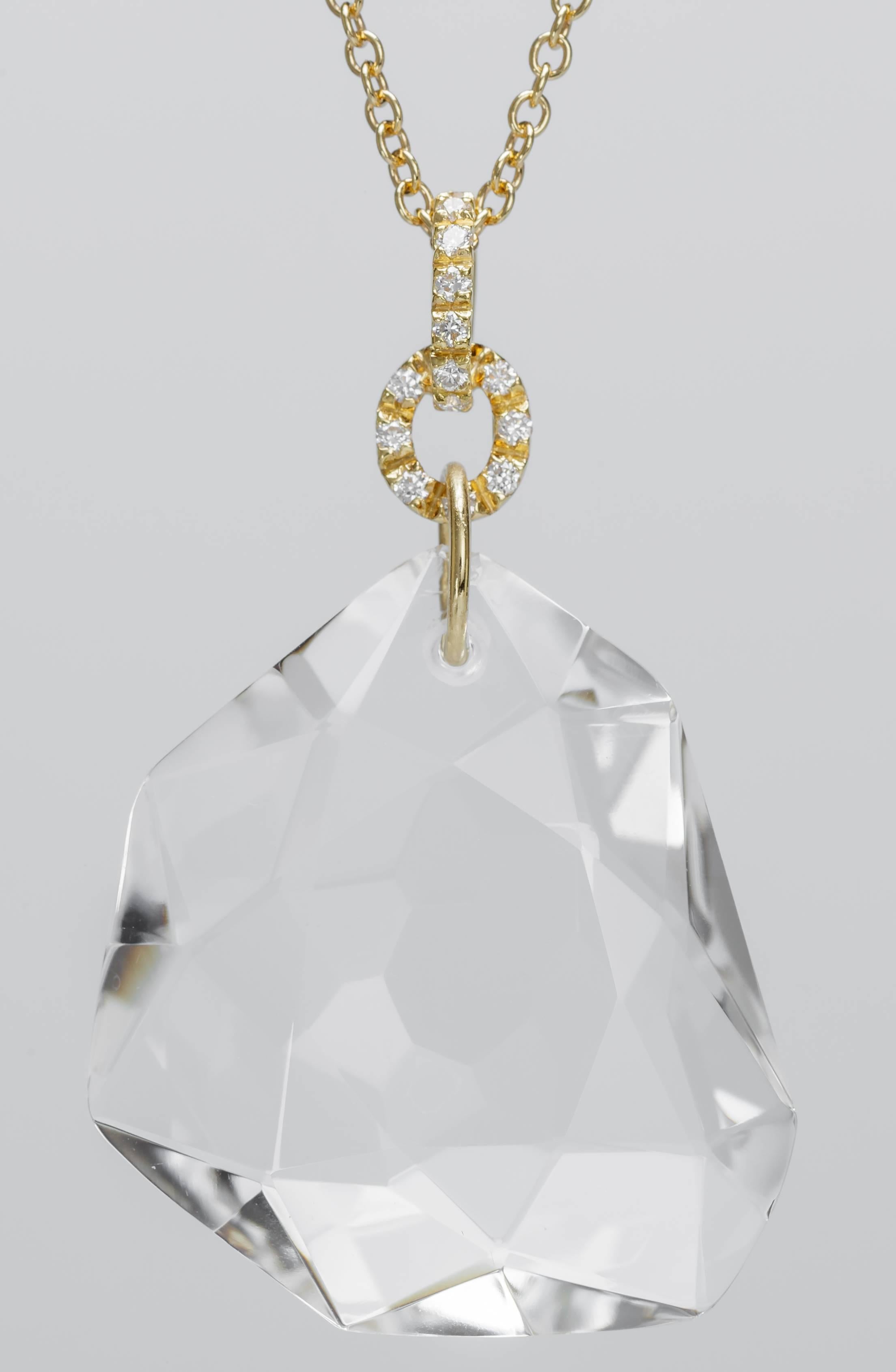 This new H. Stern DVF necklace features a 49.73ct colorless quartz rock crystal on an 18" 18K yellow gold.  The pendant's bail is set with diamonds totaling 0.22ct.  The necklace has a lobster clasp.  The quartz measures 34mm tall, 30mm wide,