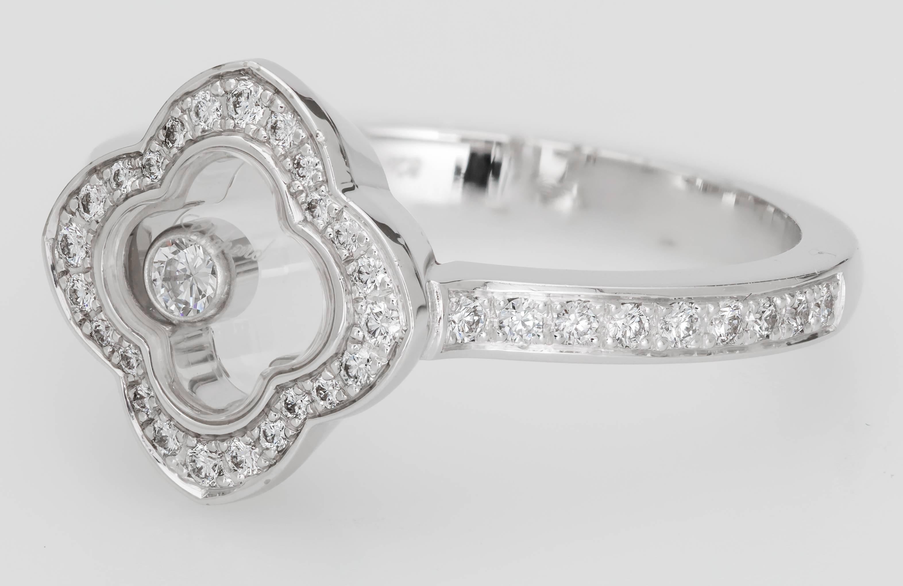 This new Chopard Happy Clover diamond ring features 42 diamonds totaling 0.20 carats and one floating 0.05 carat diamond.  The ring is 18K white gold and is a size 6.5.  It has some minor marks from being on display.