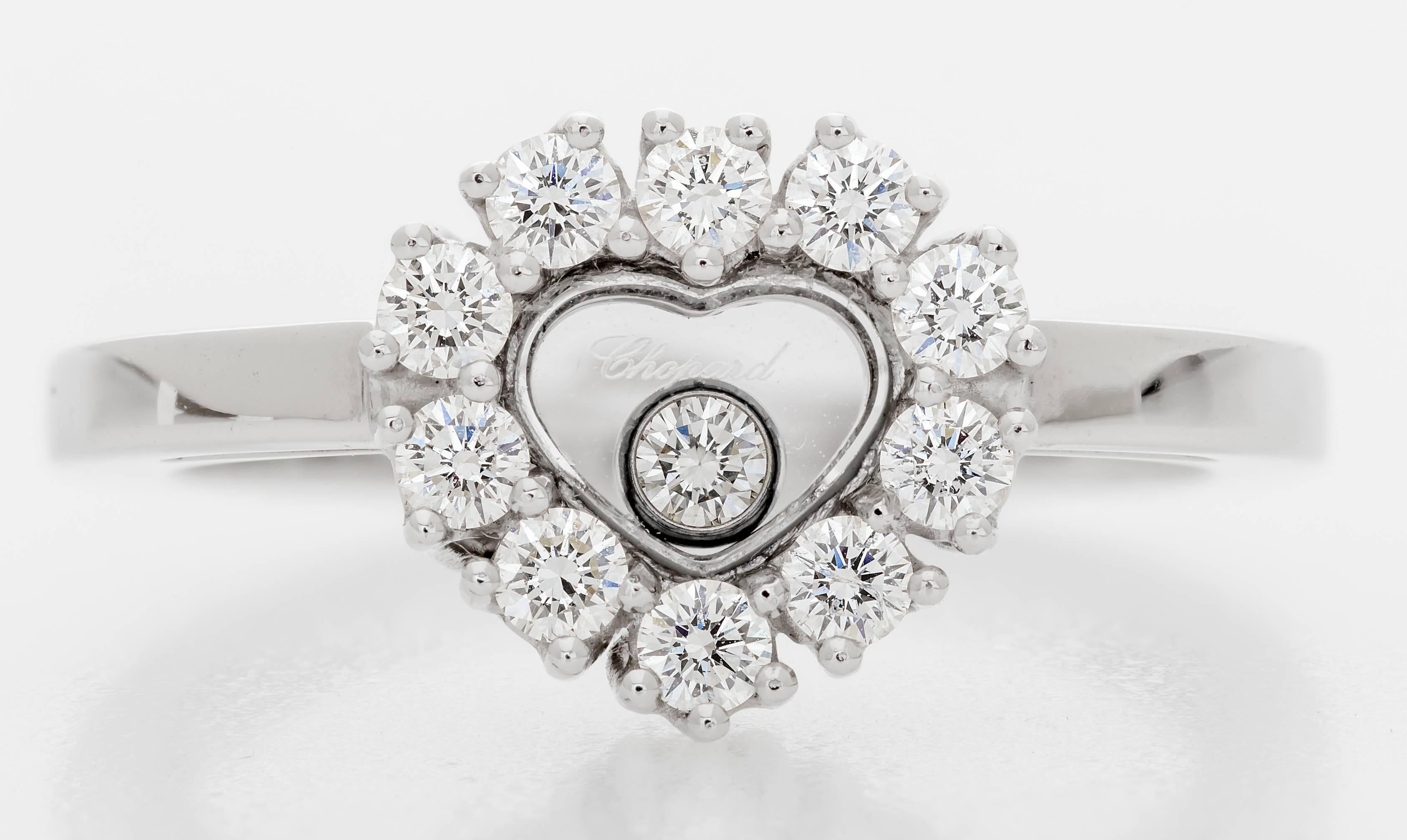 This new Chopard Happy Heart diamond ring features a floating diamond surrounded by a heart.  The heart contains 10 hearts totaling 0.34ct and the floating diamond is 0.05ct.  The band is 18k white gold and is hallmarked.  The ring is a size 6 and