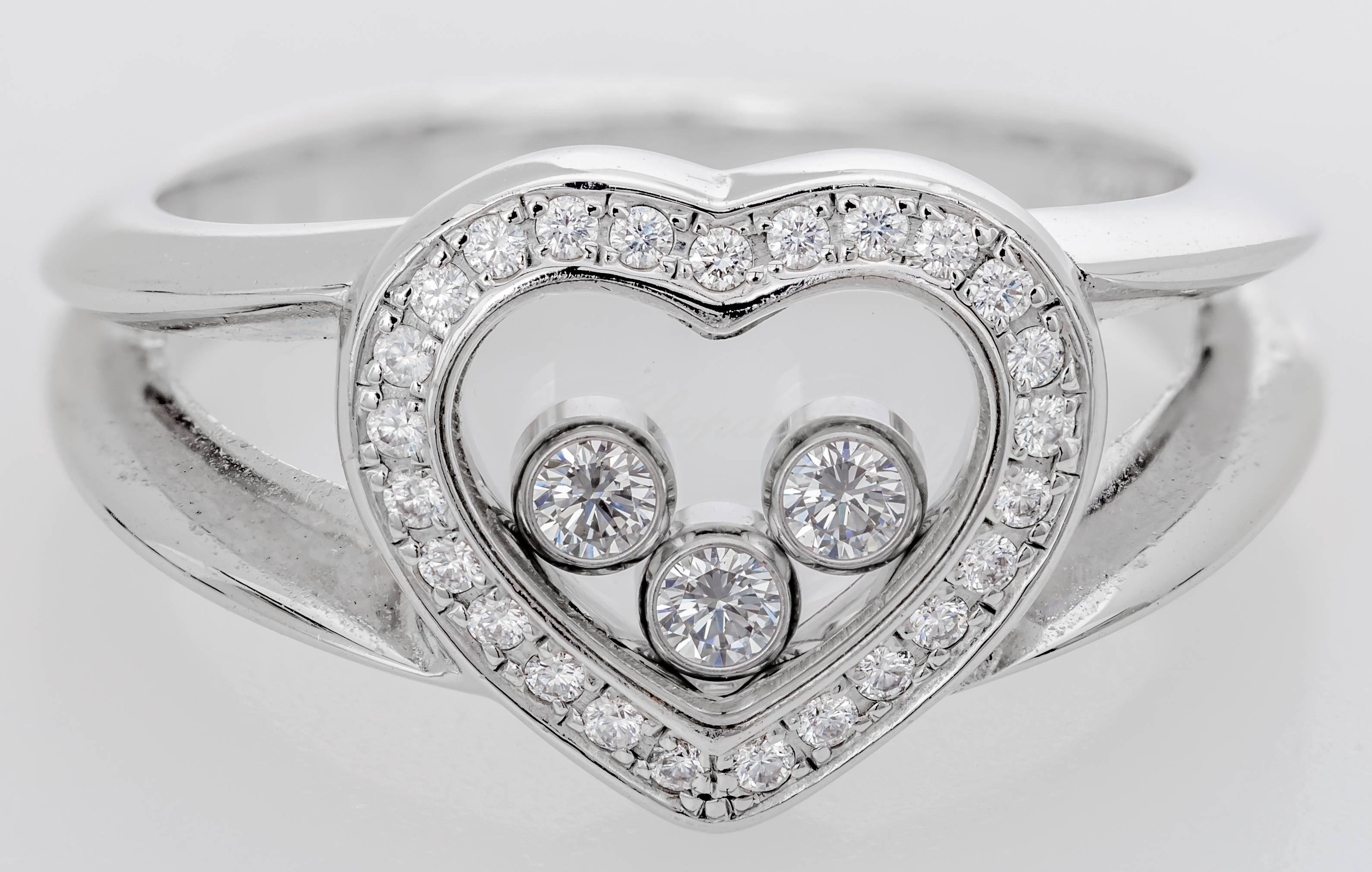 This new Chopard Happy Heart ring features three floating diamonds inside of a heart.  The heart is made of 25 diamonds totaling 0.10 ct with the three floating diamonds totaling 0.17 ct.  The ring is 18k white gold.  The ring is a size 5.5 and it