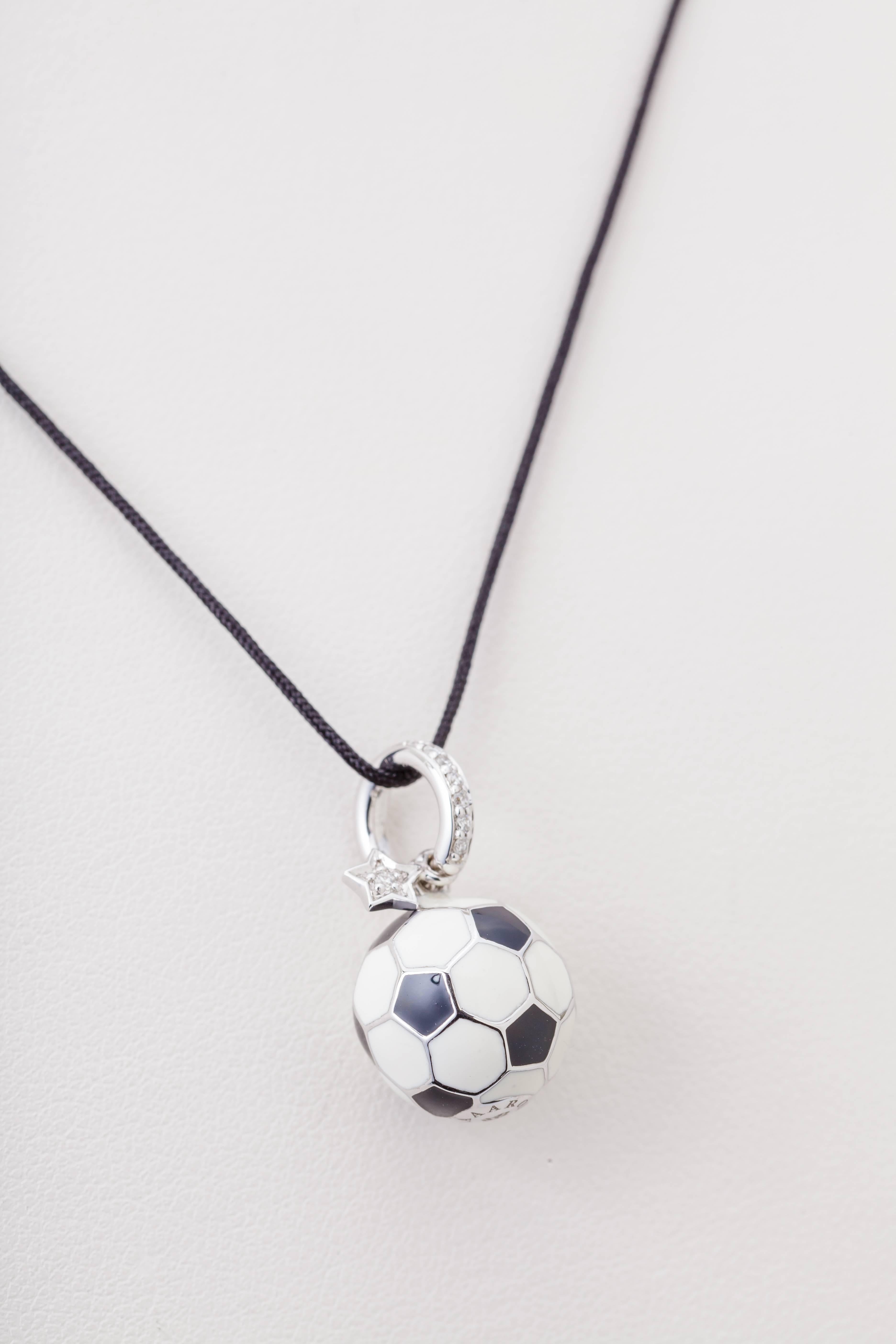 This 18k white gold Aaron Basha soccer ball dangle charm has white and black enamel and is set with diamonds totaling 0.11ct.