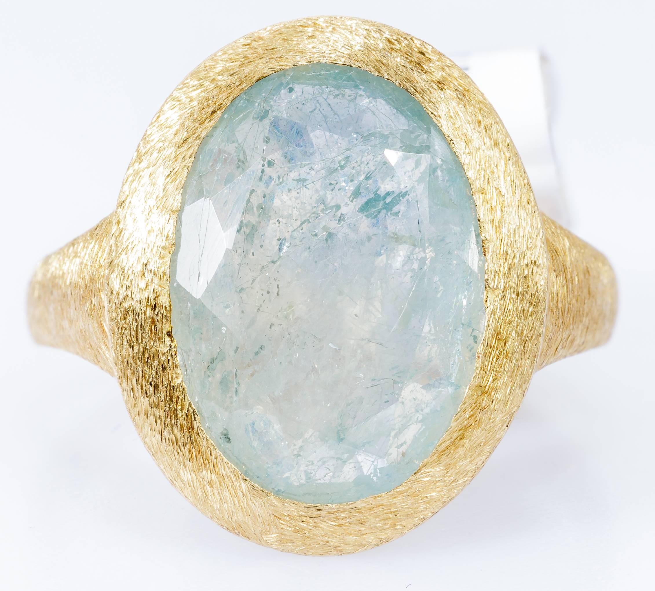 This Yvel ring features a natural blue-green sapphire set in 18k yellow gold with a satin finish. The ring is size 7. 

The stone measures 13.5mm x 10mm. The carat weight is 7.50 ct. The top of the ring including bezel setting is 17mm x 14mm. 