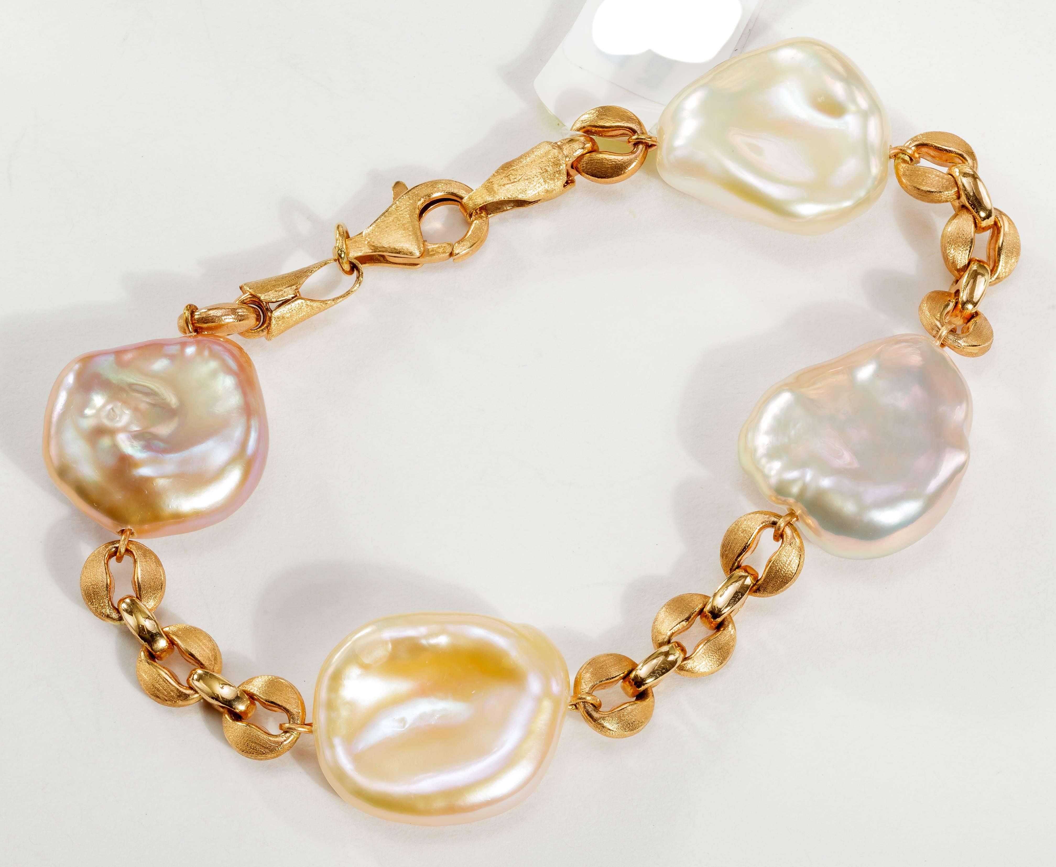 This Yvel chain bracelet features 4 freshwater Keshi pearls linked by 18k rose gold.  This bracelet measures 7 inches. 