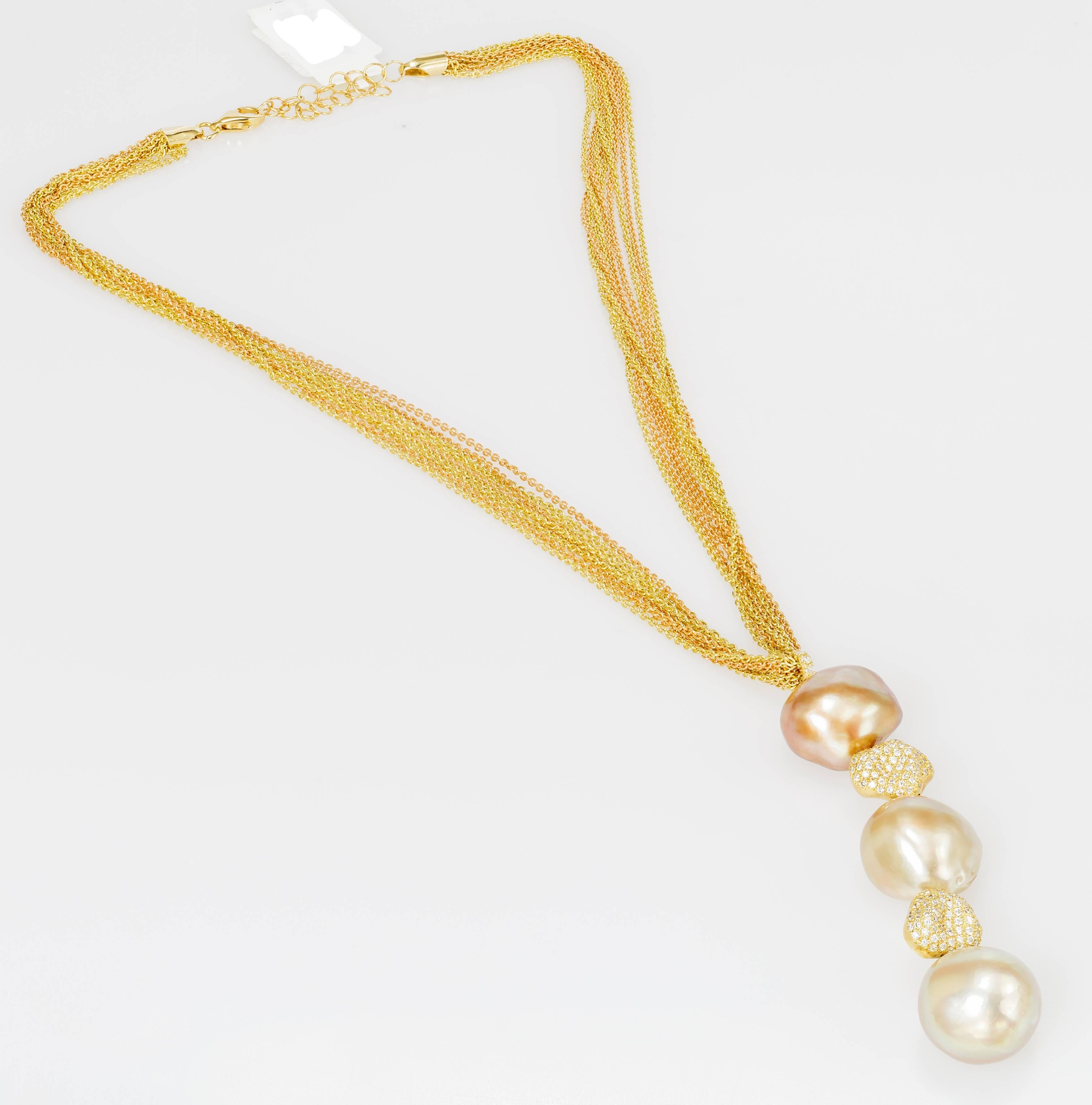 This 18k yellow and rose gold Yvel necklace features 3 South Sea baroque pearls. The gold beads on the pendant are set with diamonds totaling 1.13 ct.  The multi-strand mixed metal chain is 16 inches long and the pendant extends from there.