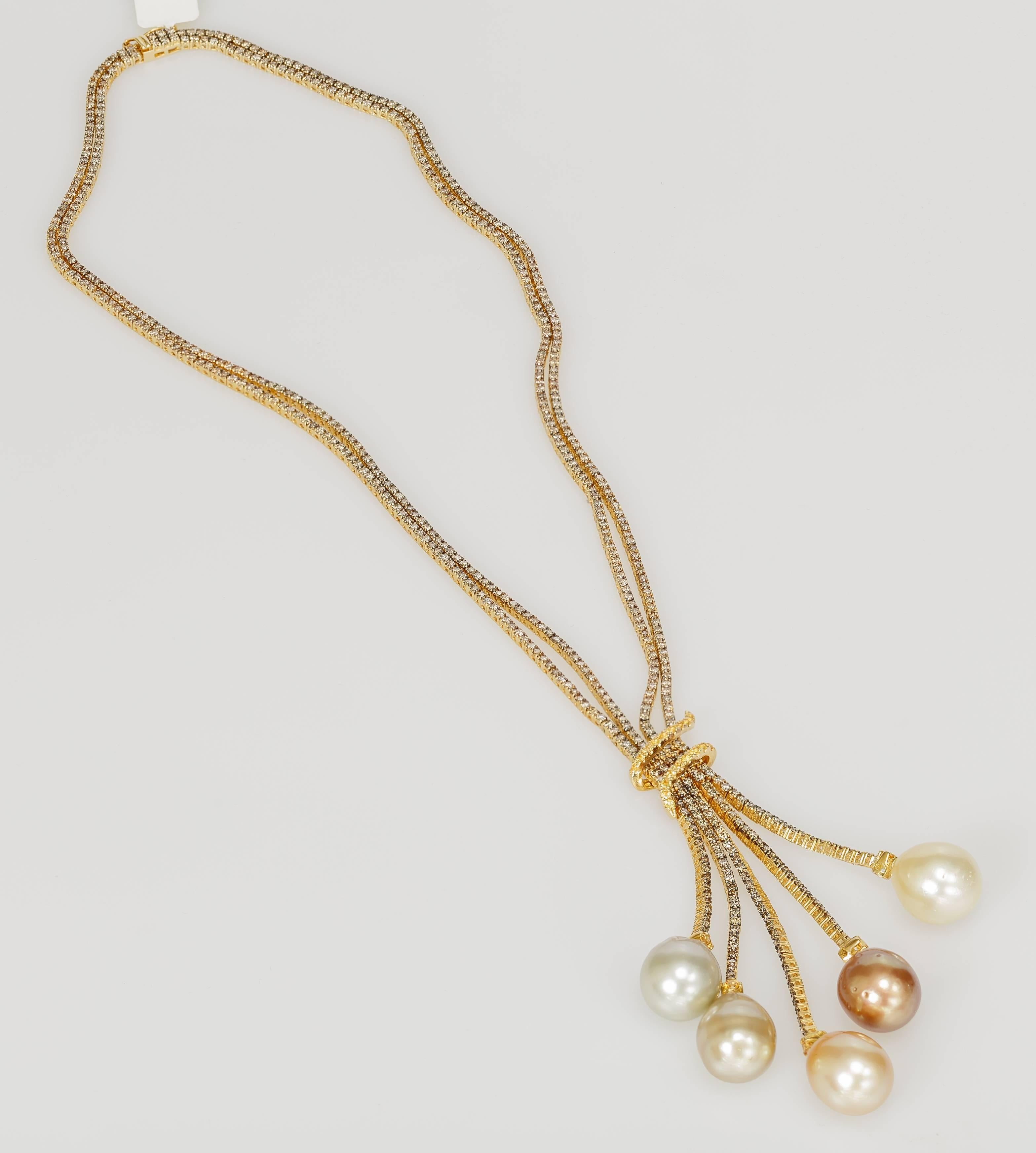 This Yvel necklace features six multicolored pearls hanging from 18k yellow gold. The double chain is set with cognac diamonds totaling 10.83 ct. The orangey-yellow sapphires total 0.49 ct. The pearls measure 13-14.5mm. The chain measures 16 inches