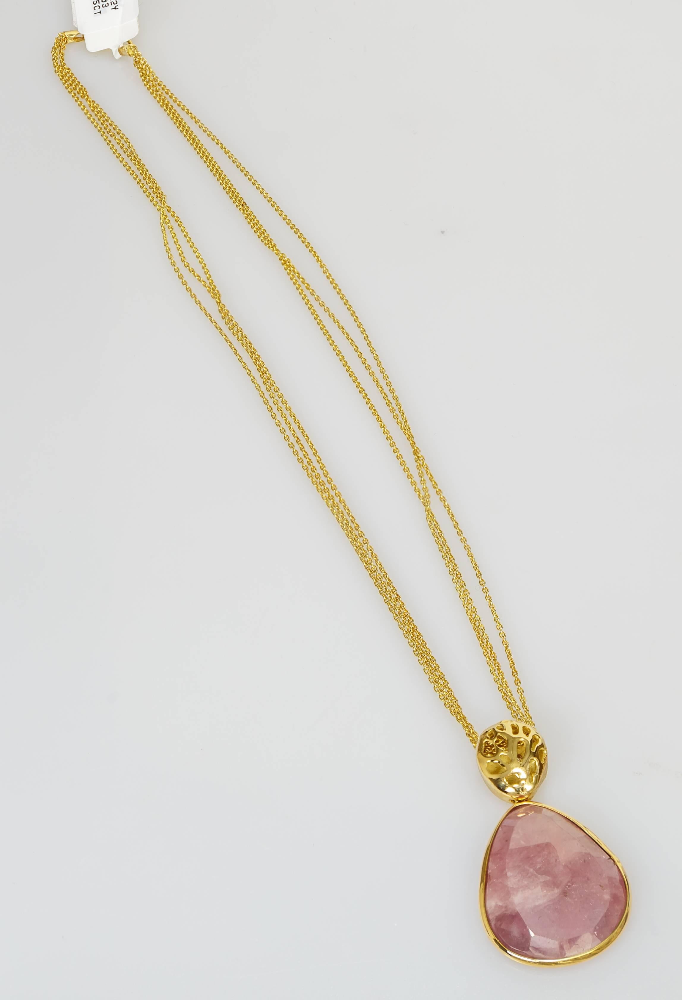 This Yvel pendant necklace features a 29.50 ct. natural colored dark pink sapphire and 18k yellow gold pendant set on an 18k yellow gold chain.  The chain measures 17 inches long.