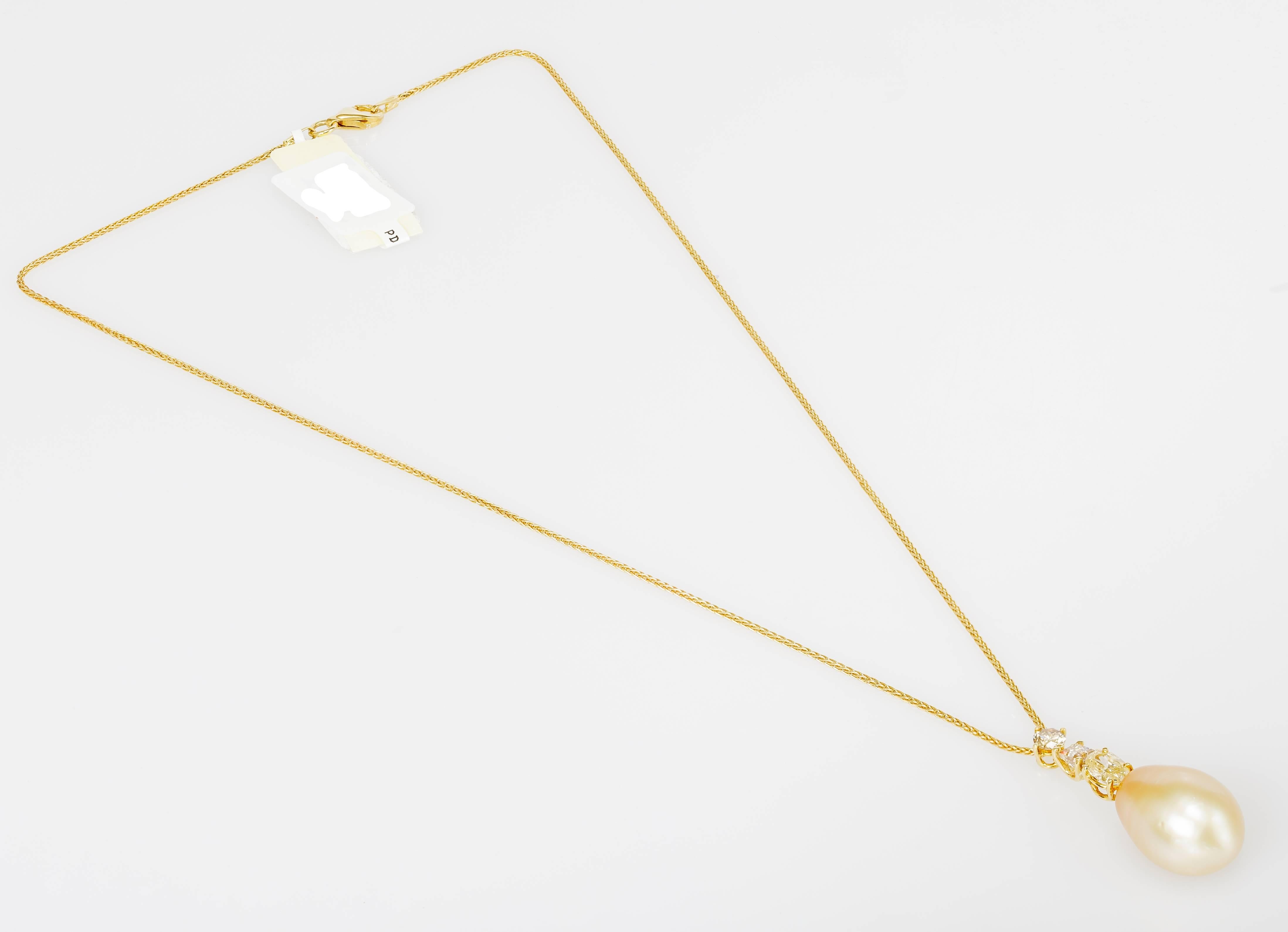 This Yvel necklace features a South Sea pearl on a pendant set with three cognac diamonds totaling 1.18 ct.  The 18k yellow gold chain measures 16 inches long.