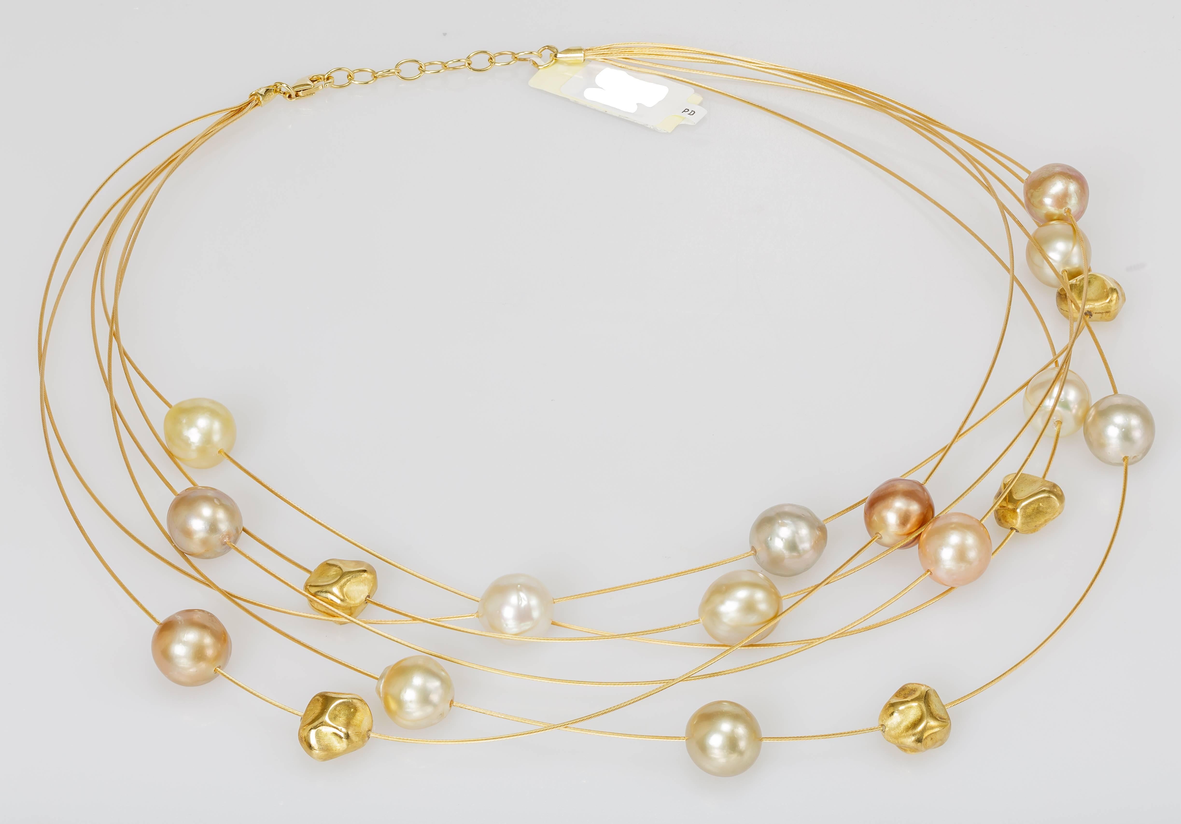 This Yvel multi-row necklace features multicolored South Sea pearls on thin 18k yellow gold wires. The necklace measures 16 inches long.