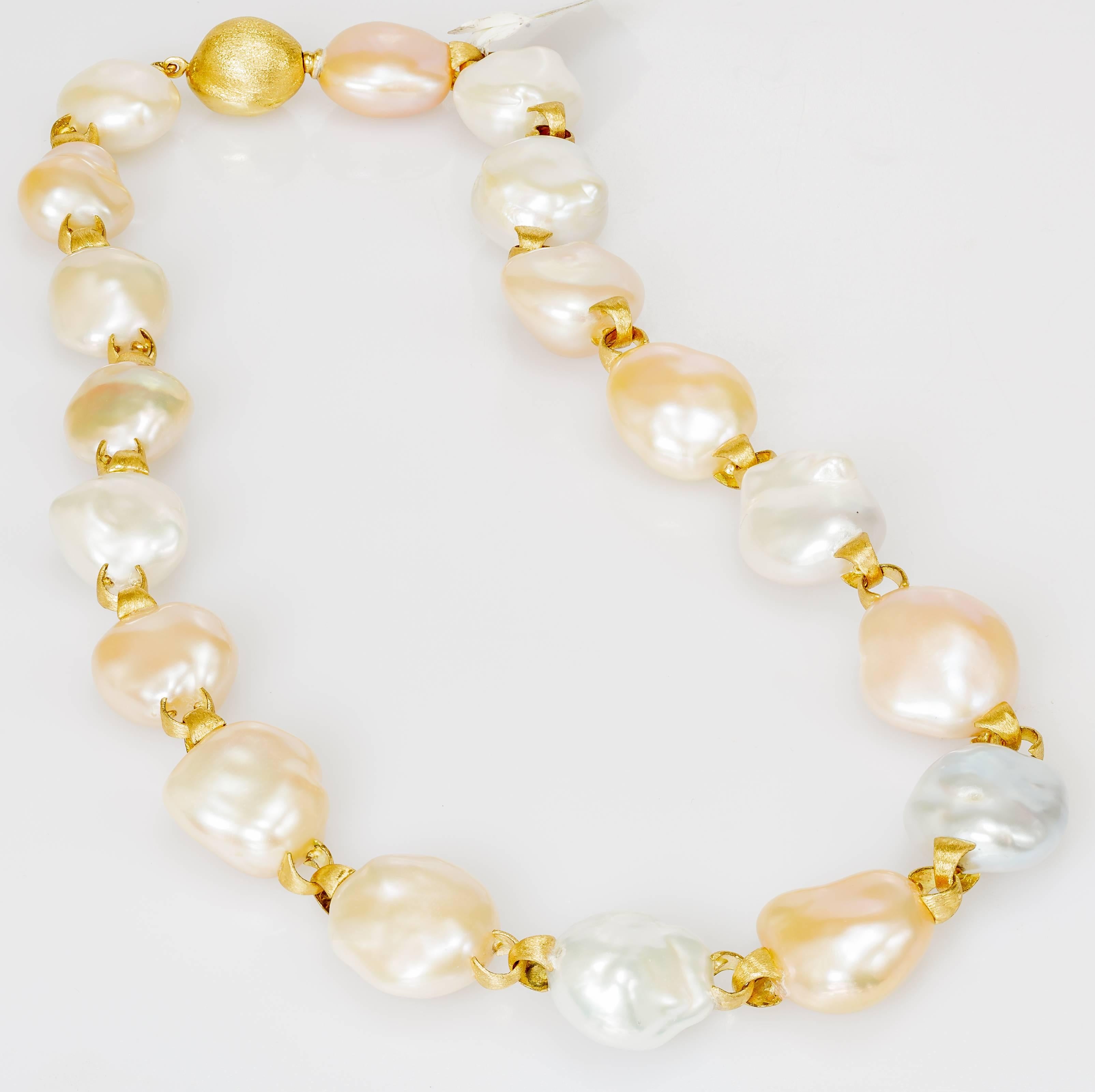 This Yvel necklace features multicolored baroque pearls linked by 18k yellow gold.  The necklace measures 17 inches long.